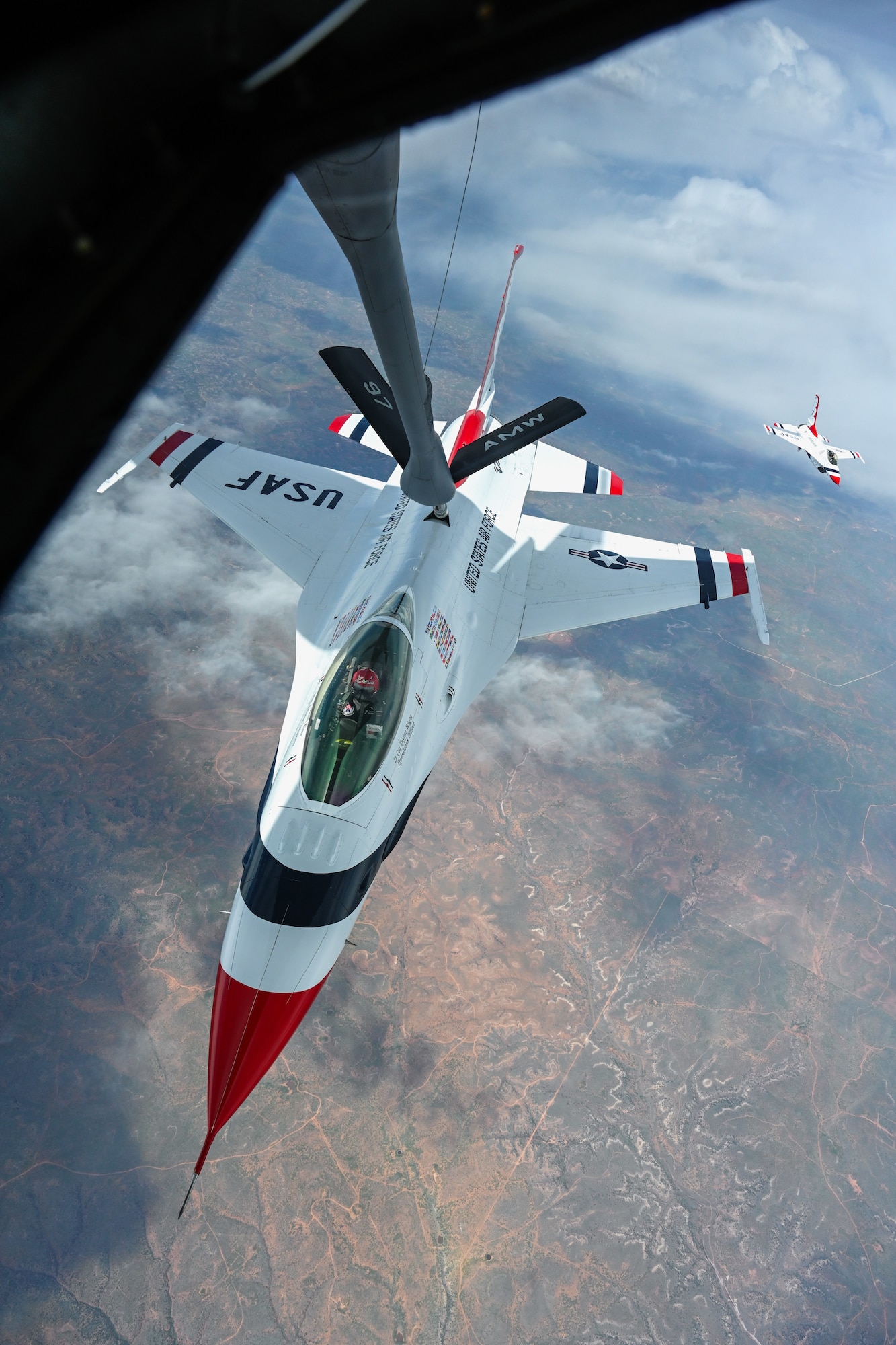 A U.S. Air Force F-16 Fighting Falcon assigned to the Thunderbirds aerial demonstration team receives fuel from a KC-135 Stratotanker assigned to the 54th Air Refueling Squadron over Texas, April 17, 2025. The Thunderbirds perform precision aerial maneuvers to demonstrate the capabilities of modern fighter aircraft and inspire the next generation of Airmen. (U.S. Air Force photo by Airman 1st Class Jonah Bliss)