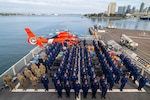 U.S. Coast Guard Cutter Kimball (WMSL 756) crew members, Tactical Law Enforcement Team South, U.S. Coast Guard Maritime Safety and Security Team Los Angeles/Long Beach, Navy, Helicopter Interdiction Tactical Squadron Jacksonville all stand at attention during an all hands event during a drug offload in San Diego April 24, 2025. The Coast Guard Cutter Kimball’s crew and their partners can operate in the most demanding open ocean environments, and the vast approaches of the Southern Pacific, where significant narcotics trafficking occurs. (U.S. Coast Guard photo by Petty Officer 3rd Class Austin Wiley)