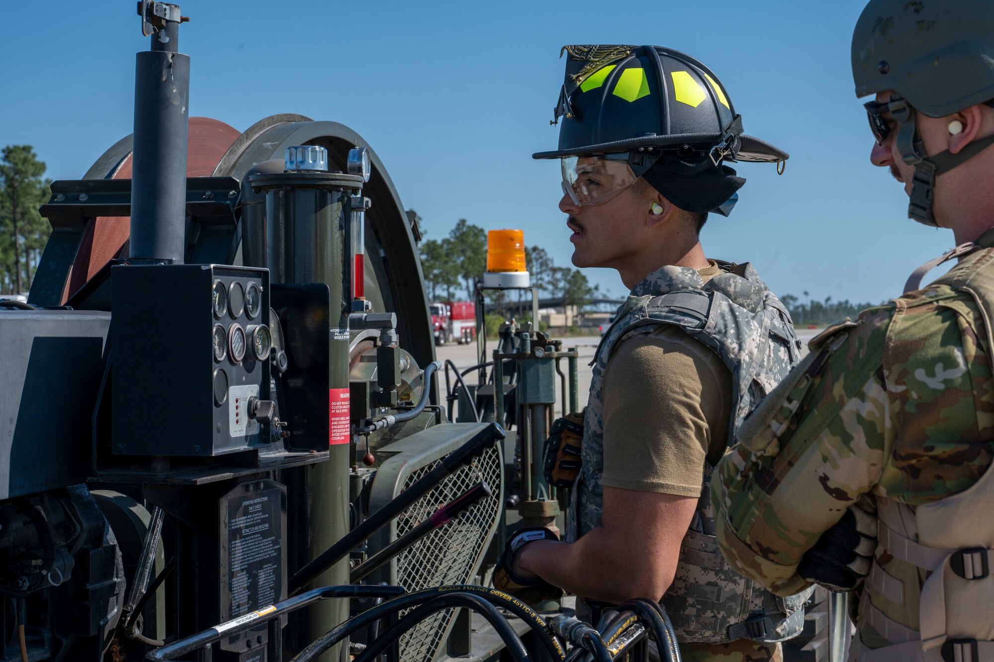 U.S. Air Force Senior Airman Jacob Turner, a fire protection specialist assigned to the 22nd Air Task Force, operates the Mobile Aircraft Arresting System during a Silver Flag exercise at Tyndall Air Force Base, Florida, April 8, 2025. The MAAS provides a rapid and reliable means of stopping aircraft in emergency situations which is crucial for maintaining air safety and operational readiness in various scenarios, including expeditionary deployments and contingency operations. Exercises like this allow the 22nd ATF to focus on essential skills necessary for executing missions in potential operational wartime environments. (U.S. photo by Airman 1st Class Samantha Thorn)