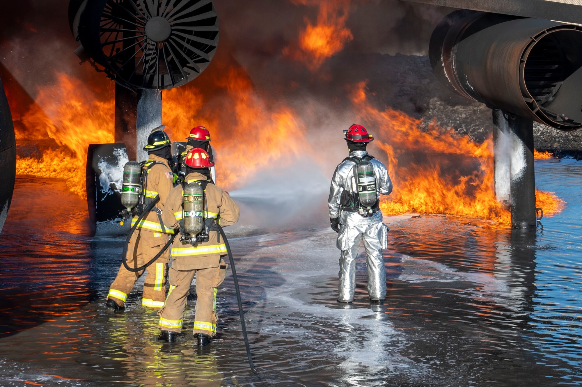 U.S. Air Force fire protection specialists, assigned to the 22nd Air Task Force, conduct Aircraft Rescue and Firefighting Training during a Silver Flag exercise at Tyndall Air Force Base, Florida, April 9, 2025. ARFT is a biannual certification training that equips firefighters with the knowledge and skills to respond to aircraft emergencies. ATFs will allow the Air Force to provide a definable unit of action that has worked and trained together throughout the AFFORGEN cycle. (U.S. photo by Airman 1st Class Samantha Thorn)