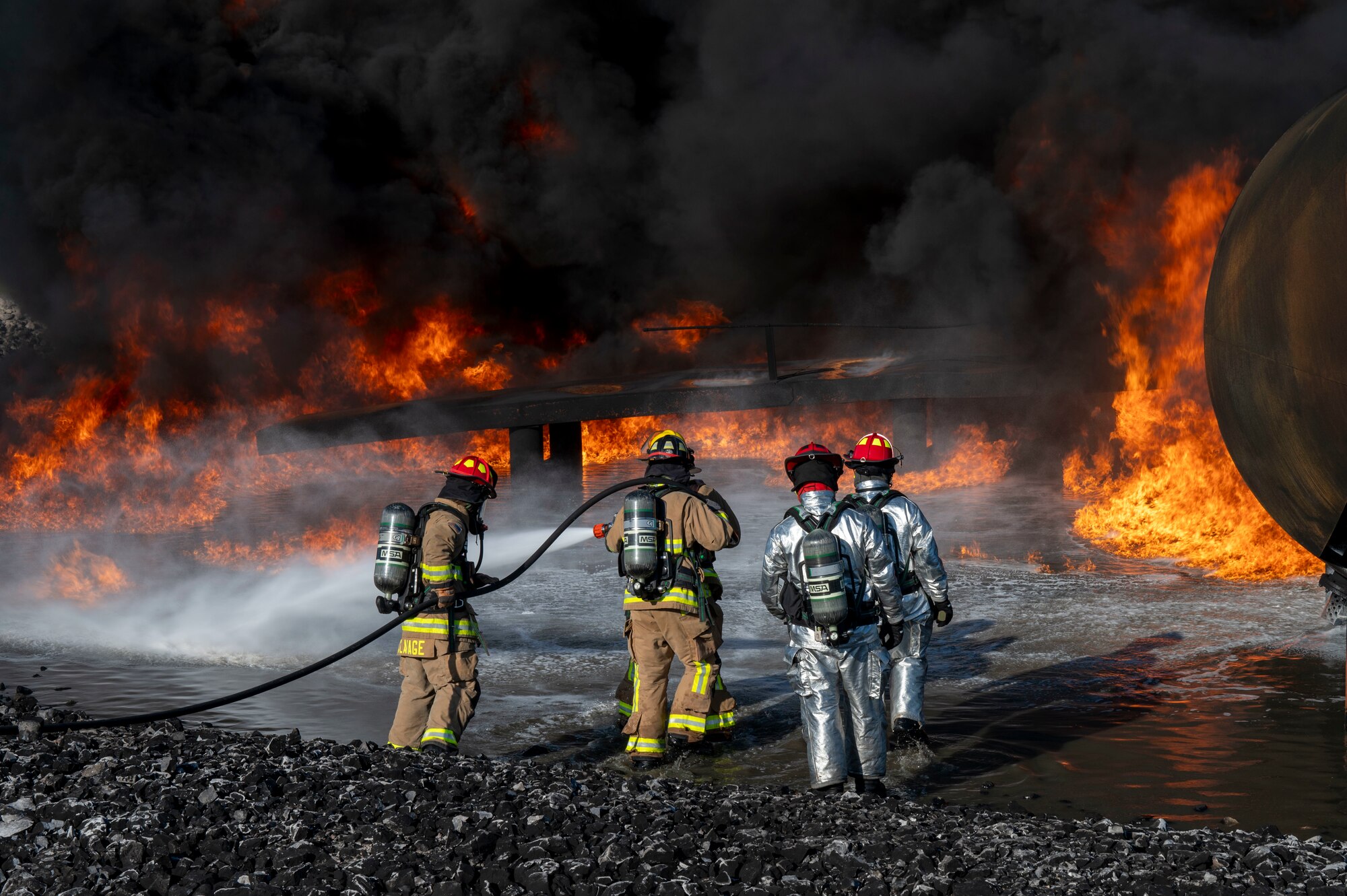 U.S. Air Force fire protection specialists, assigned to the 22nd Air Task Force, conduct Aircraft Rescue and Firefighting Training during a Silver Flag exercise at Tyndall Air Force Base, Florida, April 9, 2025. ARFT is a biannual certification training that equips firefighters with the knowledge and skills to respond to aircraft emergencies. ATFs will allow the Air Force to provide a definable unit of action that has worked and trained together throughout the AFFORGEN cycle. (U.S. photo by Airman 1st Class Samantha Thorn)