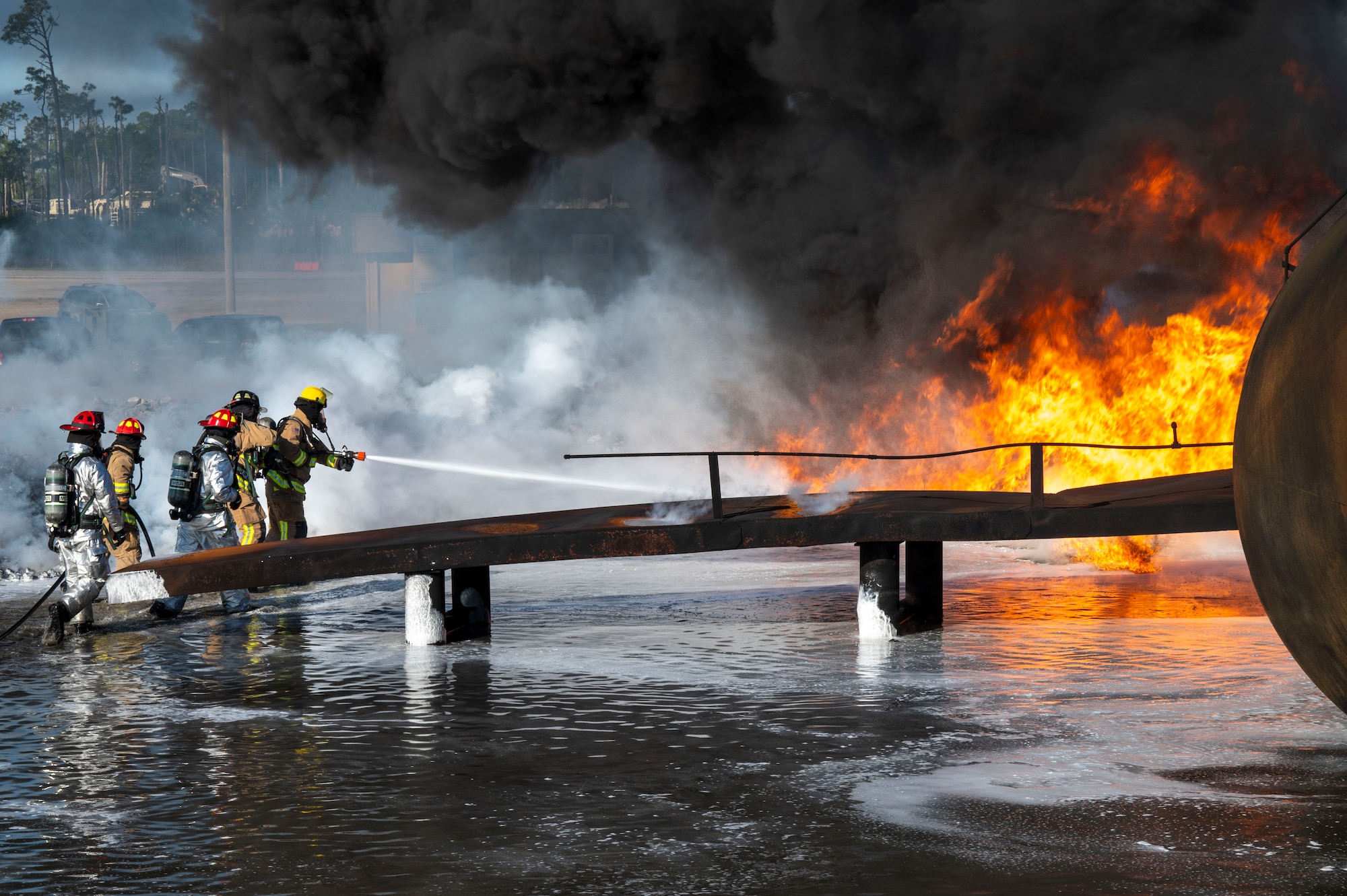 U.S. Air Force fire protection specialists, assigned to the 22nd Air Task Force, conduct Aircraft Rescue and Firefighting Training during a Silver Flag exercise at Tyndall Air Force Base, Florida, April 9, 2025. ARFT is a biannual certification training that equips firefighters with the knowledge and skills to respond to aircraft emergencies. ATFs will allow the Air Force to provide a definable unit of action that has worked and trained together throughout the AFFORGEN cycle. (U.S. photo by Airman 1st Class Samantha Thorn)