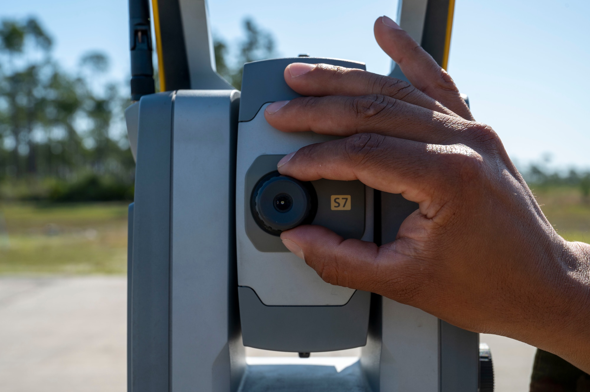 U.S. Air Force Tech Sgt. Kevin Moncrief, an air traffic control specialist 22nd Air Task Force, verifies the position of the approach lights on the runway using a survey total station during a Silver Flag exercise at Tyndall Air Force Base, Florida, April 9, 2025. A survey total station is an electronic surveying instrument that measures distance and elevation. This exercise was designed to evaluate and enhance the operational skills of 22nd Air Task Force, ensuring that they are an agile and responsive asset within our Air Force. (U.S. photo by Airman 1st Class Samantha Thorn)