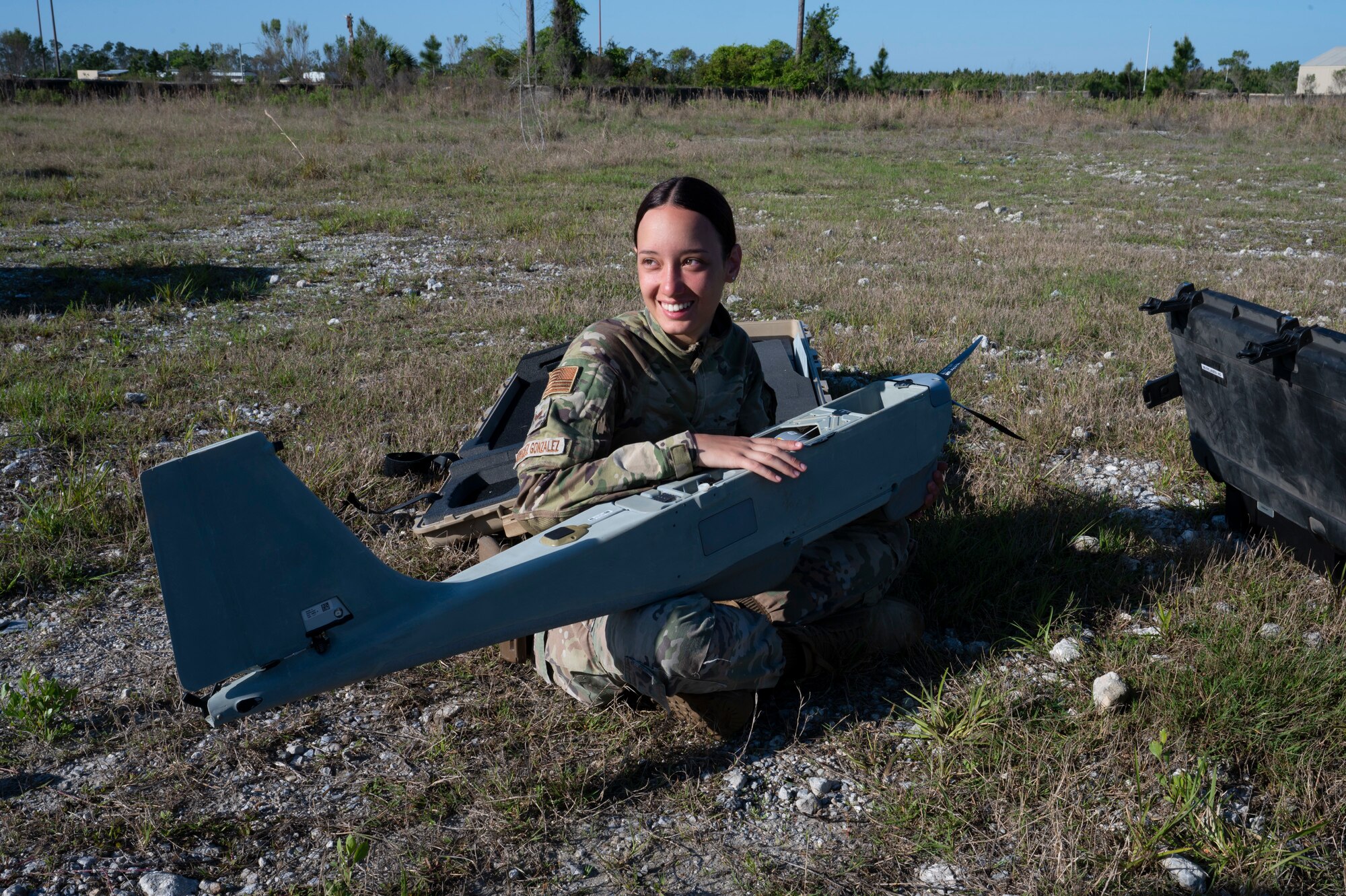 U.S. Air Force Senior Airman Jeirilys Rodriguez Gonzalez, installation patrolman assigned to the 22nd Air Task Force, holds a RQ-20B Puma during a Silver Flag exercise at Tyndall Air Force Base, Florida, April 10, 2025. Exercises like this allow the 22nd ATF to focus on essential skills necessary for executing missions in potential operational wartime environments. (U.S. photo by Airman 1st Class Samantha Thorn)