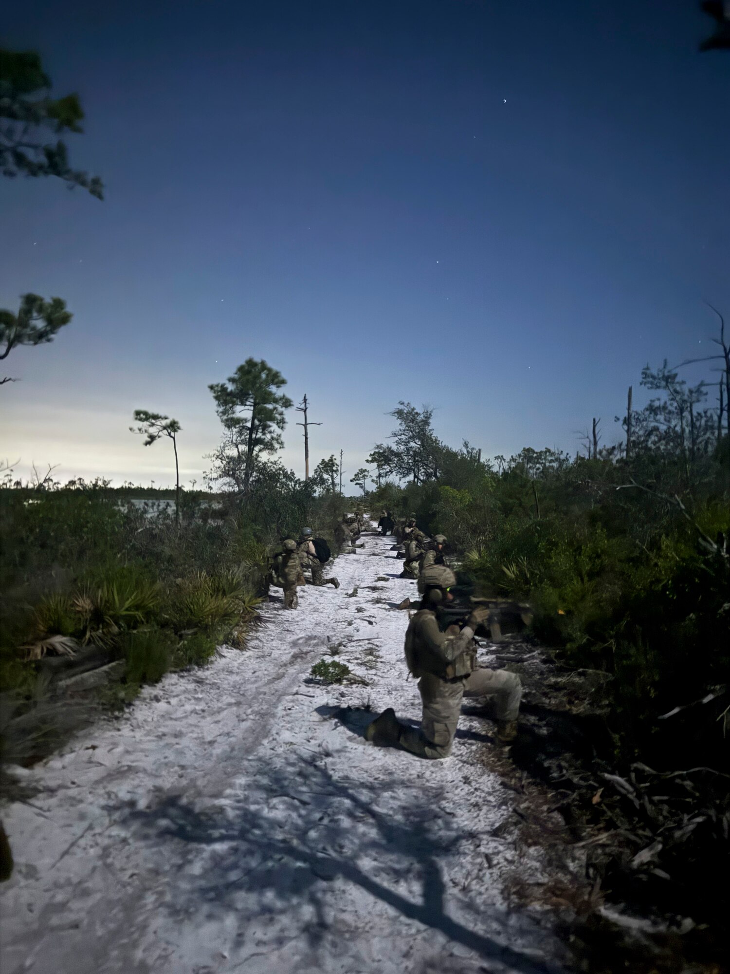U.S. Air Force Airmen assigned to the 22nd Air Task Force, conduct a simulated nighttime reconnaissance operation during a Silver Flag exercise at Tyndall Air Force Base, Florida, April 10, 2025. This exercise was designed to evaluate and enhance the operational skills of the 22nd ATF, ensuring that they are an agile and responsive asset within our Air Force. (U.S. photo by Airman 1st Class Samantha Thorn)