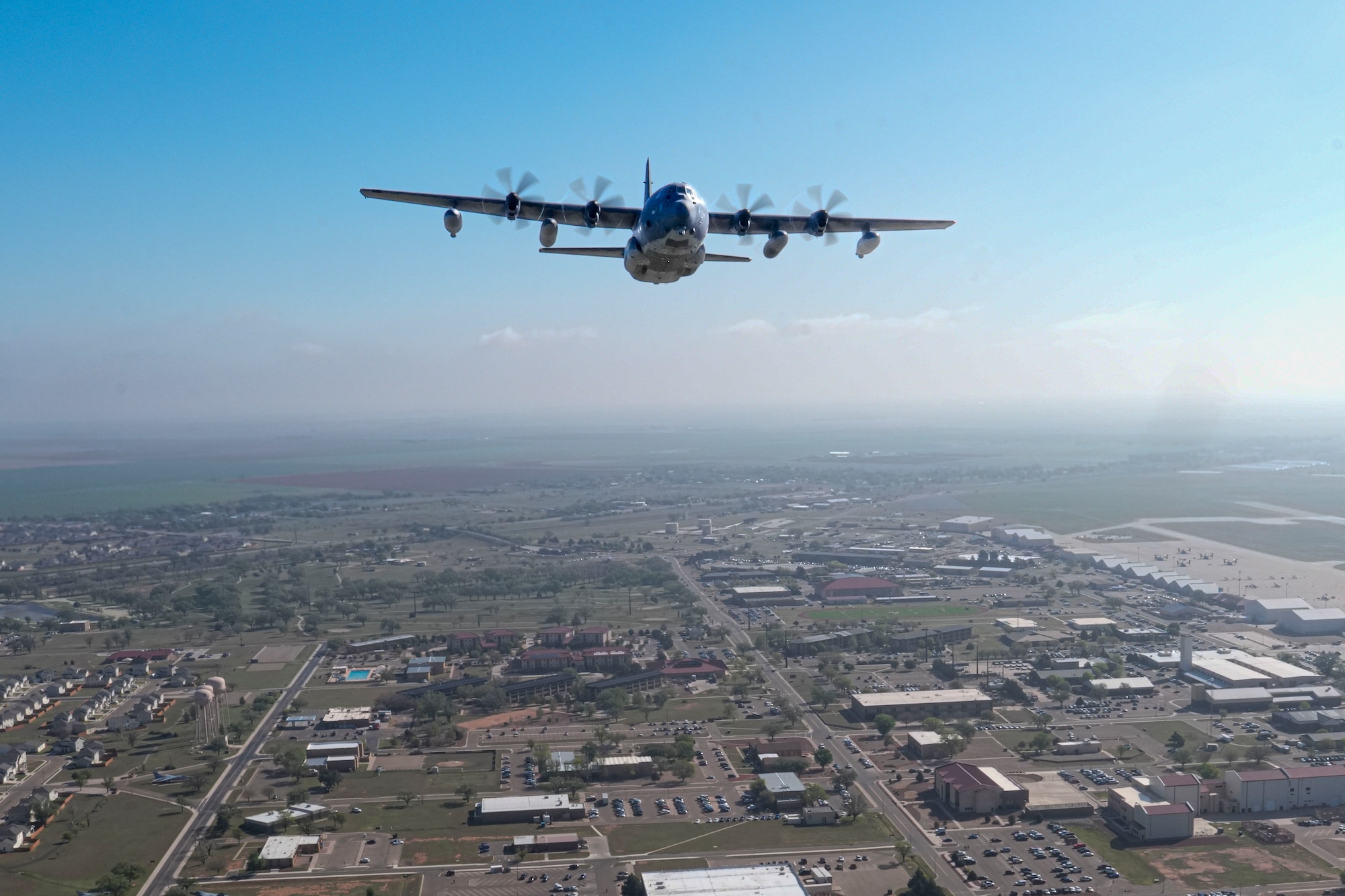 An MC-130 two-ship formation conducts a flyover during the ceremony for Operation Eagle Claw at Cannon Air Force Base