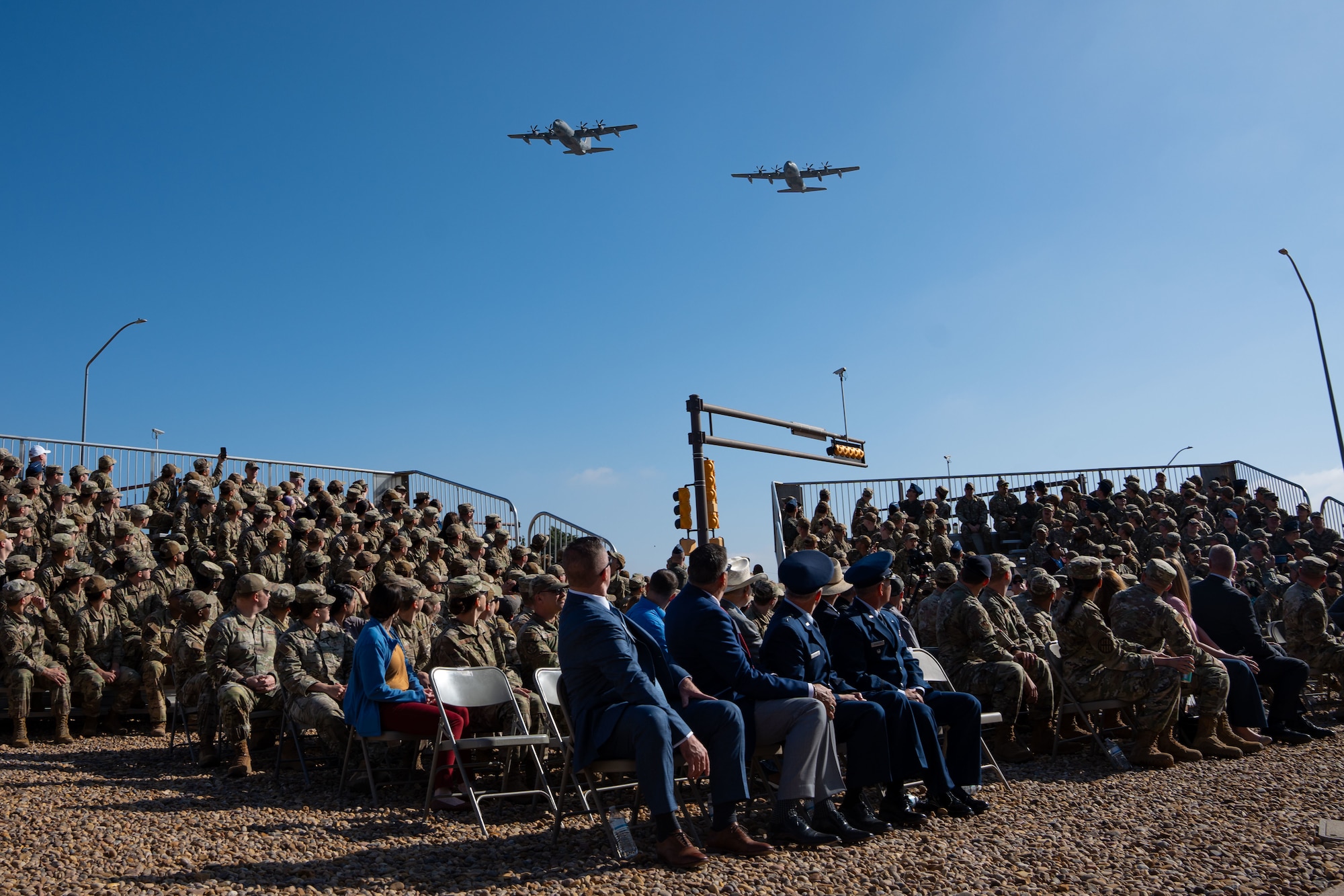 An MC-130J Commando II two-ship formation conducts a flyover during the ceremony for Operation Eagle Claw at Cannon Air Force Base, New Mexico