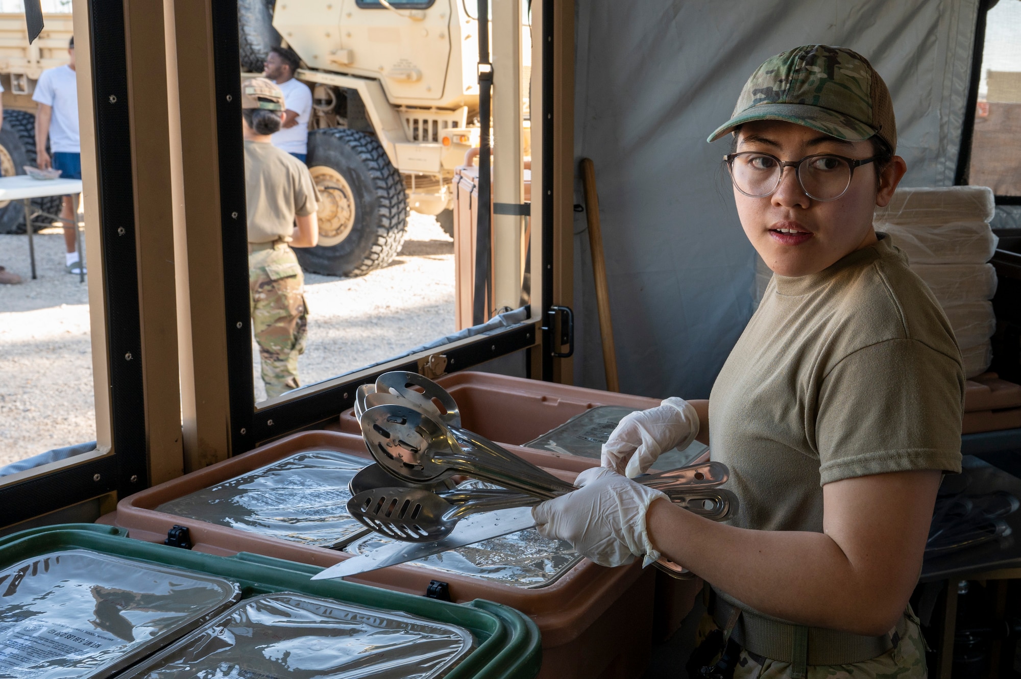 U.S. Air Force Airman 1st Class Denmari Camposagrado, a food service shift worker assigned to the 22nd Air Task Force, prepares to serve food during a Silver Flag exercise at Tyndall Air Force Base, Florida, April 9, 2025. This exercise was designed to evaluate and enhance the operational skills of 22nd ATF, ensuring that they are an agile and responsive asset within our Air Force. (U.S. photo by Airman 1st Class Samantha Thorn)