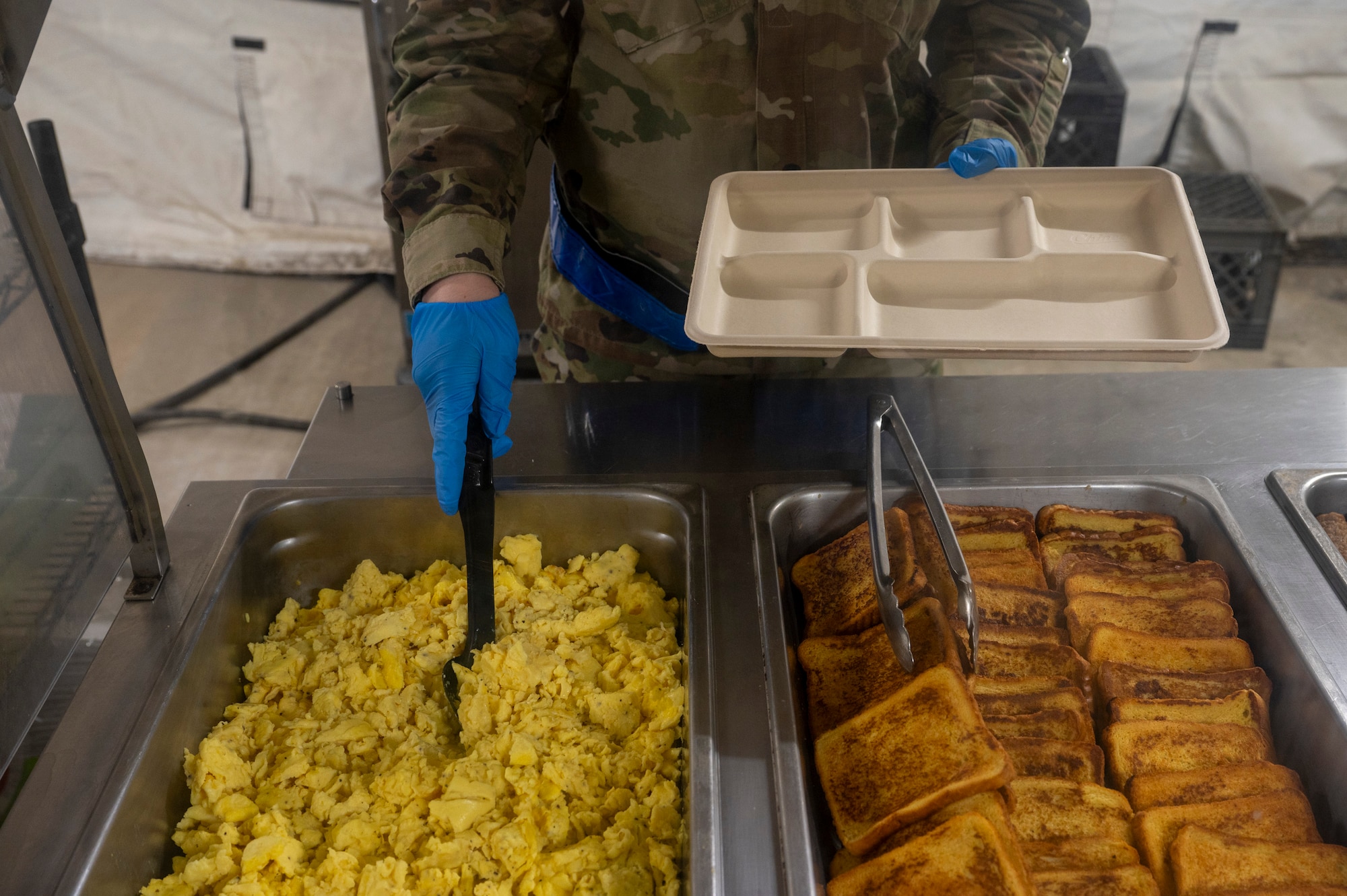 U.S. Air Force Tech. Sgt. Patience Templeton, food section chief assigned to the 22nd Air Task Force, serves food during a Silver Flag exercise at Tyndall Air Force Base, Florida, April 10, 2025. This exercise was designed to evaluate and enhance the operational skills of 22nd ATF, ensuring that they are an agile and responsive asset within our Air Force. (U.S. photo by Airman 1st Class Samantha Thorn)