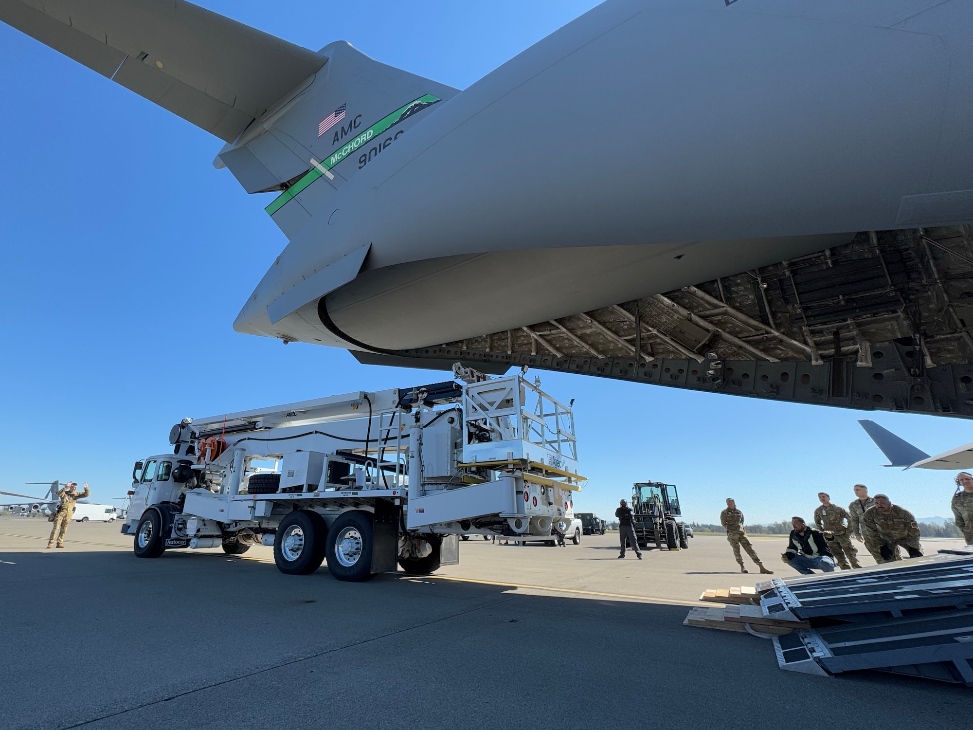 Team McChord Airmen and civilians across 62d Aerial Port Squadron, 62d Maintenance Group and the 4th Airlift Squadron loaded an Altec high-reach crane onto a C-17 Globemaster III at Joint Base Lewis-McChord, Washington, April 17, 2025. The crane was transported to Arizona to facilitate the replacement of the pitch trim actuator in the tail of another 62d Airlift Wing C-17. This crucial transport ensures Team McChord Airmen and aircraft are returned to a mission-capable status to support today’s global airlift mission.
