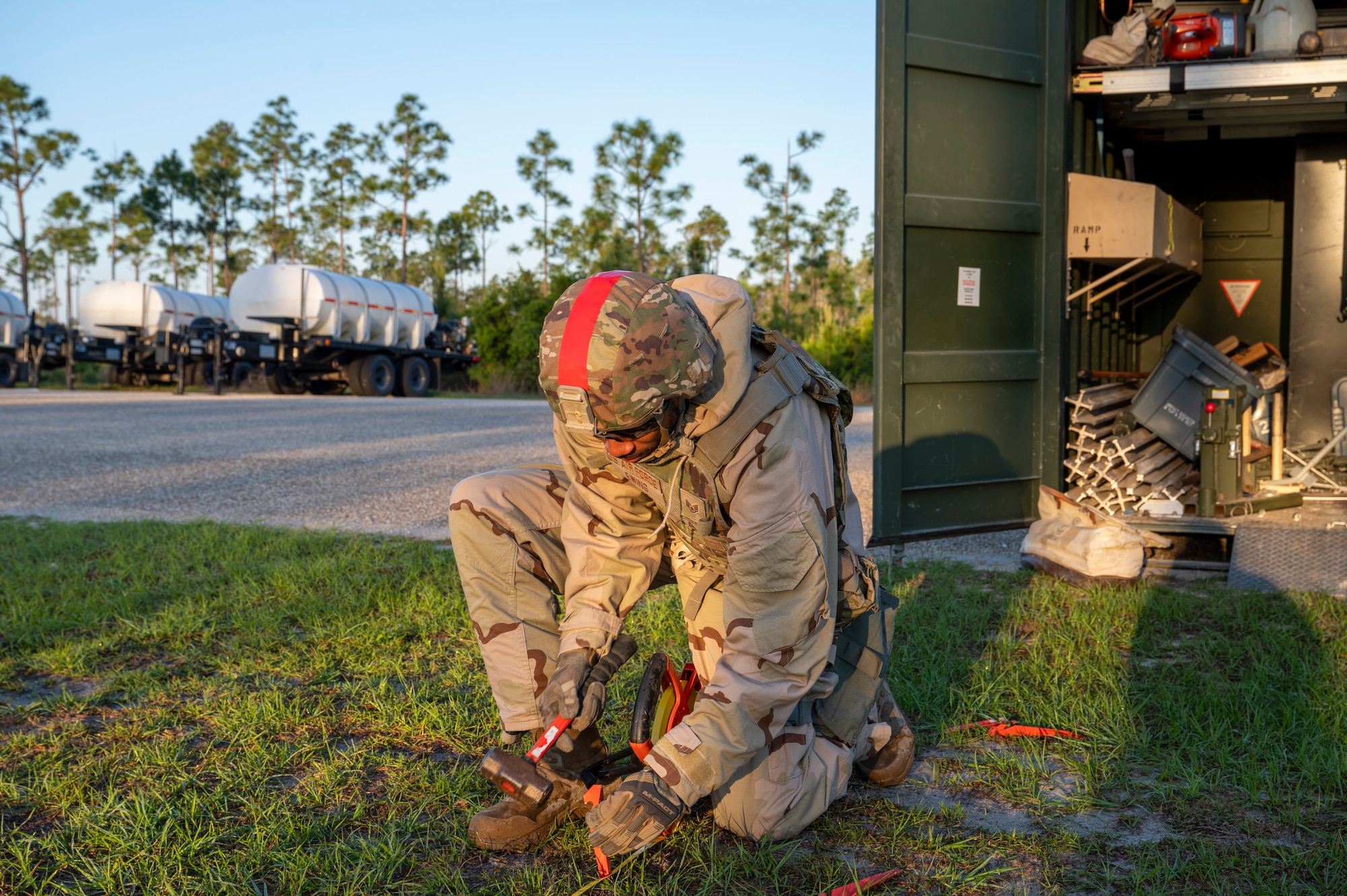 U.S. Air Force Staff Sgt. Ajala Ewing, a structures section chief assigned to the 22nd Air Task Force, hammers a stake to establish a baseline for airfield matting during a Silver Flag exercise at Tyndall Air Force Base, Florida, April 10, 2025. The 22nd ATF participated in rigorous exercises and diverse training programs to ensure that ATFs are fully prepared to execute assigned missions. (U.S. photo by Airman 1st Class Samantha Thorn)