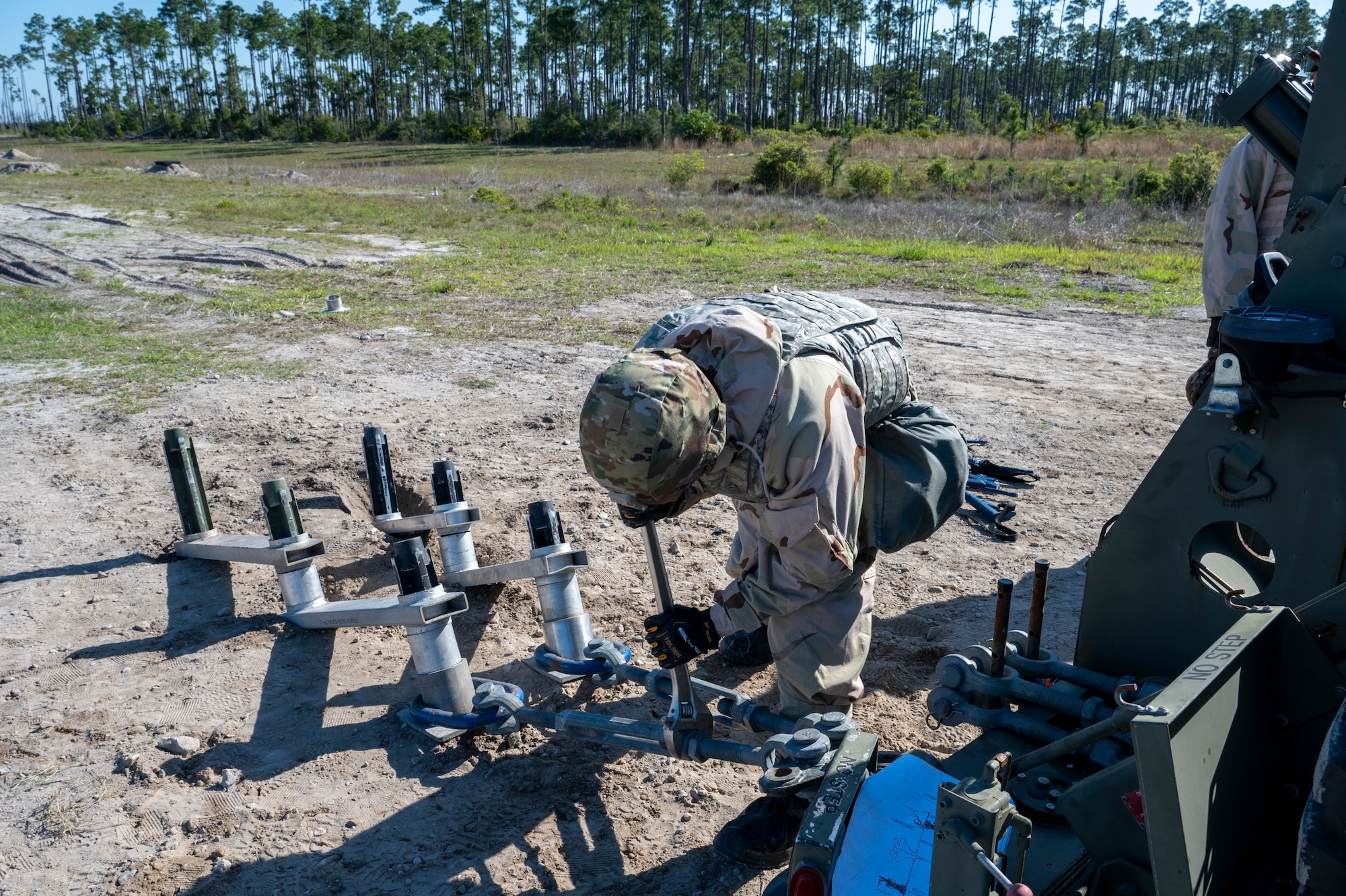 U.S. Air Force Staff Sgt. Joaquin Padilla-Puga, a cable and antenna maintenance specialist assigned to the 22nd Air Task Force, uses a wrench to secure the mobile arresting aircraft system during a Silver Flag exercise at Tyndall Air Force Base, Florida, April 10, 2025. The MAAS provides a rapid and reliable means of stopping aircraft in emergency situations. The 22nd ATF participated in rigorous exercises and diverse training programs to ensure that ATFs are fully prepared to execute assigned missions. (U.S. photo by Airman 1st Class Samantha Thorn)