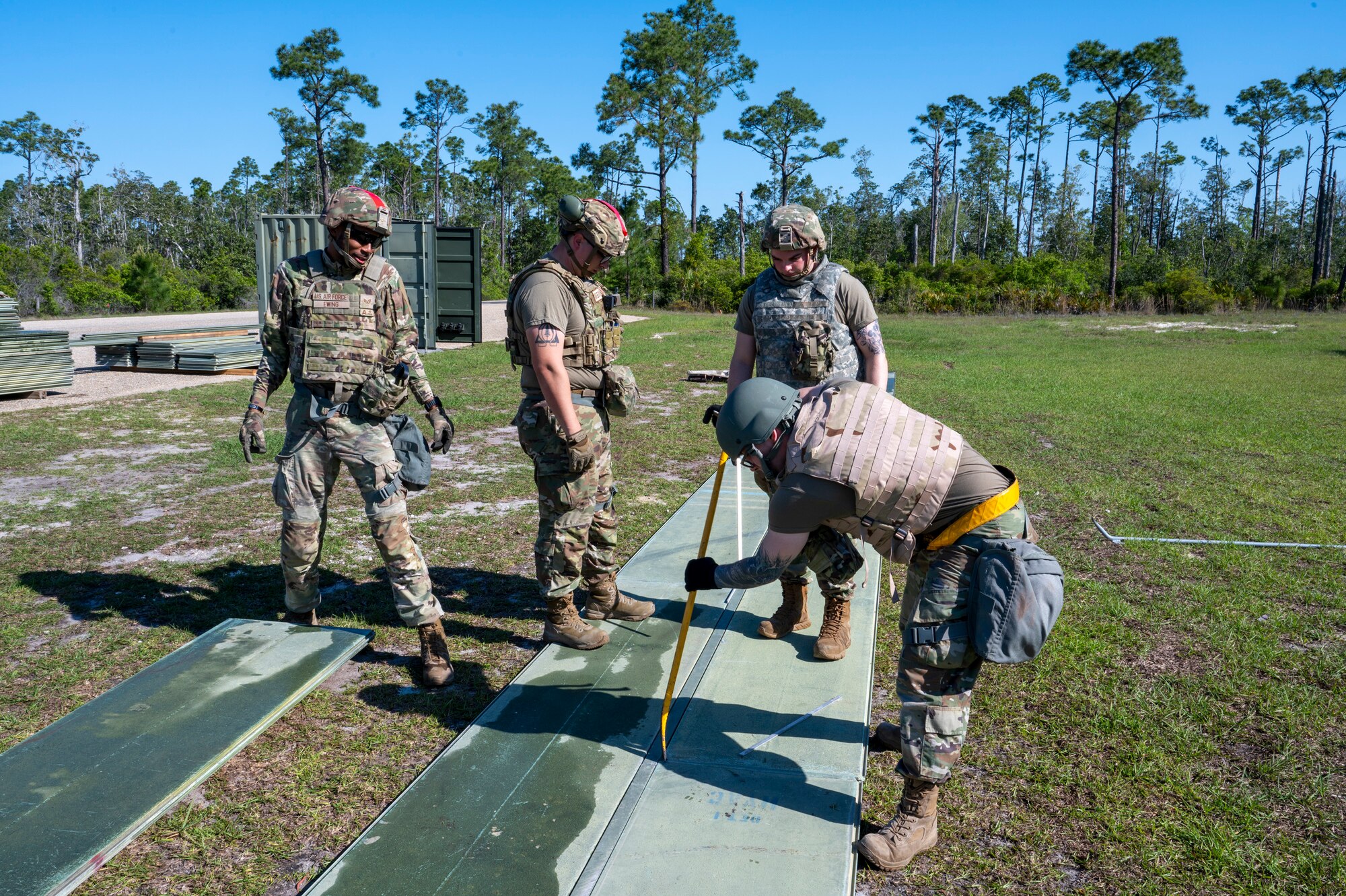 U.S. Air Force Airmen assigned to the 22nd Air Task Force, build a helipad to enable safe landing of rotary aircraft during a Silver Flag exercise at Tyndall Air Force Base, Florida, April 10, 2025. The 22nd ATF participated in rigorous exercises and diverse training programs to ensure that ATFs are fully prepared to execute assigned missions. (U.S. photo by Airman 1st Class Samantha Thorn)