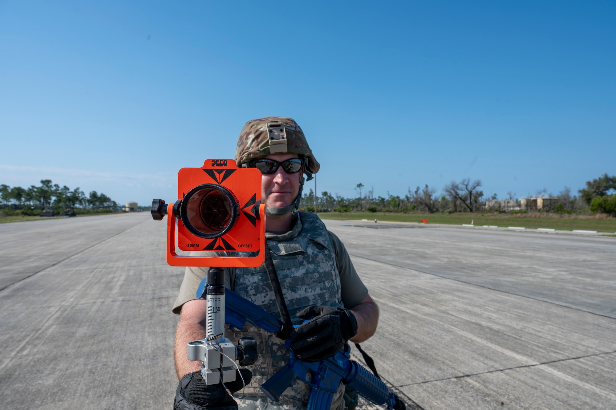 U.S. Air Force Master Sgt. Nick Porter, an engineer technician assigned to the 22nd Air Task Force, holds a survey prism during a Silver Flag exercise at Tyndall Air Force Base, Florida, April 11, 2025. This instrument is used in conjunction with the survey total station to accurately measure distances and angles. This exercise was designed to evaluate and enhance the operational skills of 22nd ATF, ensuring that they are an agile and responsive asset within our Air Force. (U.S. photo by Airman 1st Class Samantha Thorn)