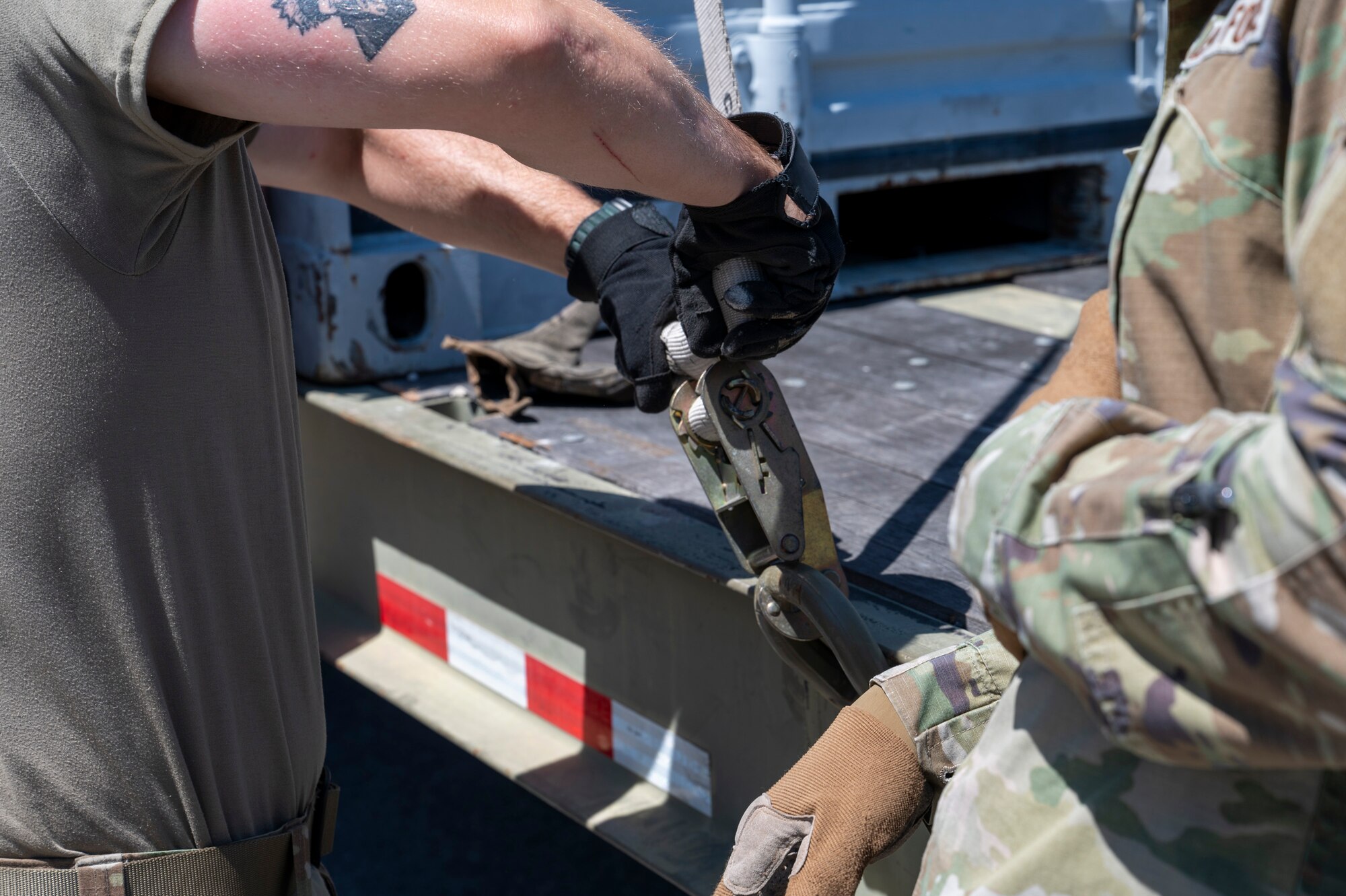 U.S. Air Force Airmen assigned to the 22nd Air Task Force, wrap up the loose end of a ratchet strap during exercise MAGPIE at Tyndall Air Force Base, Florida, April 14, 2025. The 22nd ATF participated in rigorous exercises and diverse training programs to ensure that ATFs are fully prepared to execute assigned missions. (U.S. photo by Airman 1st Class Samantha Thorn)