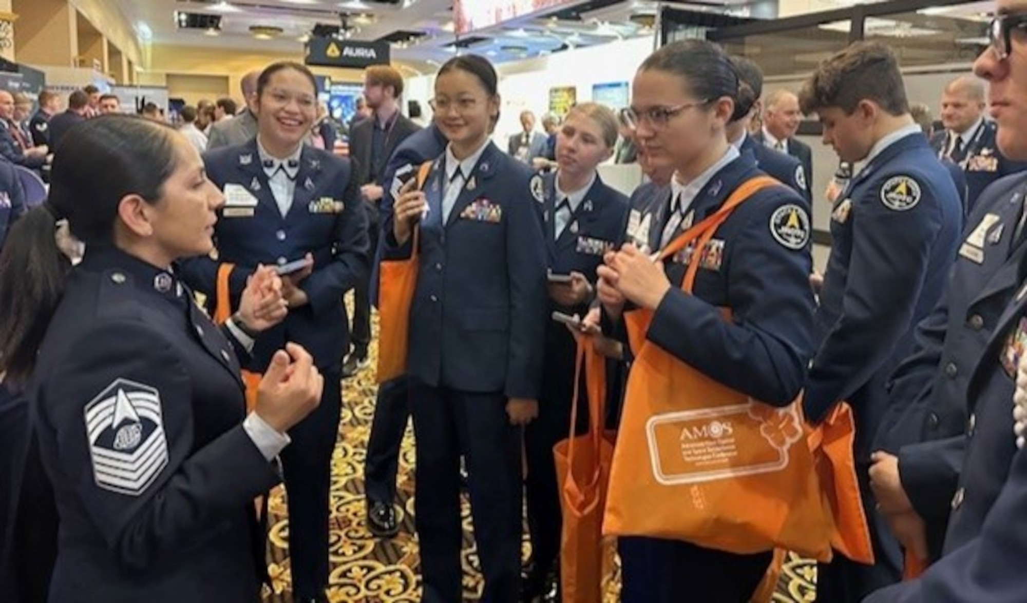 Space Systems Command’s (SSC) Sr. Enlisted Leader, CMSgt. Jacqueline Sauvé, explains space acquisition and the role of the U.S. Space Force to STEM students visiting SSC’s exhibit booth on April 10 at Space Symposium Colorado Springs, CO. More than 100 students visited the field commands’ shared booth during the last day of the conference; many who shared their aspiration to become a Guardian after graduation.