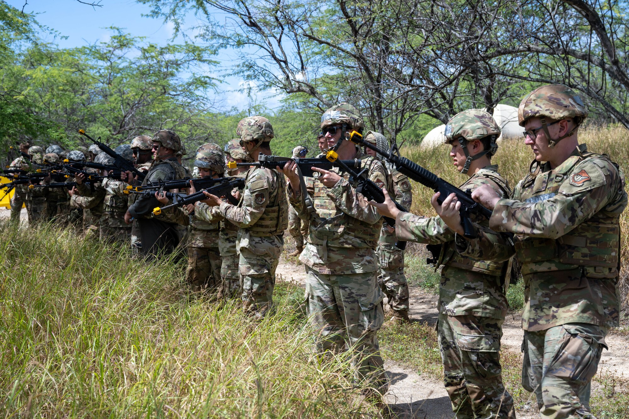 U.S. Air Force Airmen clear out their M4 assault rifles after finishing their training session.