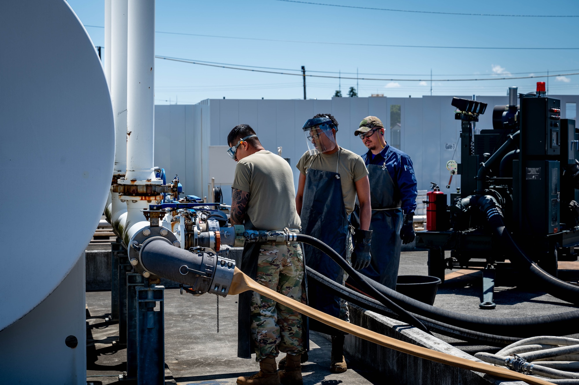 From left, U.S. Air Force Airman 1st Class Juan Aparicio, Senior Airman Ronald Perry, 374th Logistics Readiness Squadron war reserve materiel technicians, and Yamane Kiyoshi, 374 LRS identification and condition verifier, perform a periodic functional check.