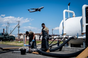 U.S. Air Force Senior Airman Blake Torres, left, and Airman 1st Class Juan Aparicio, 374th Logistics Readiness Squadron war reserve materiel technicians, set up a hose evacuation.