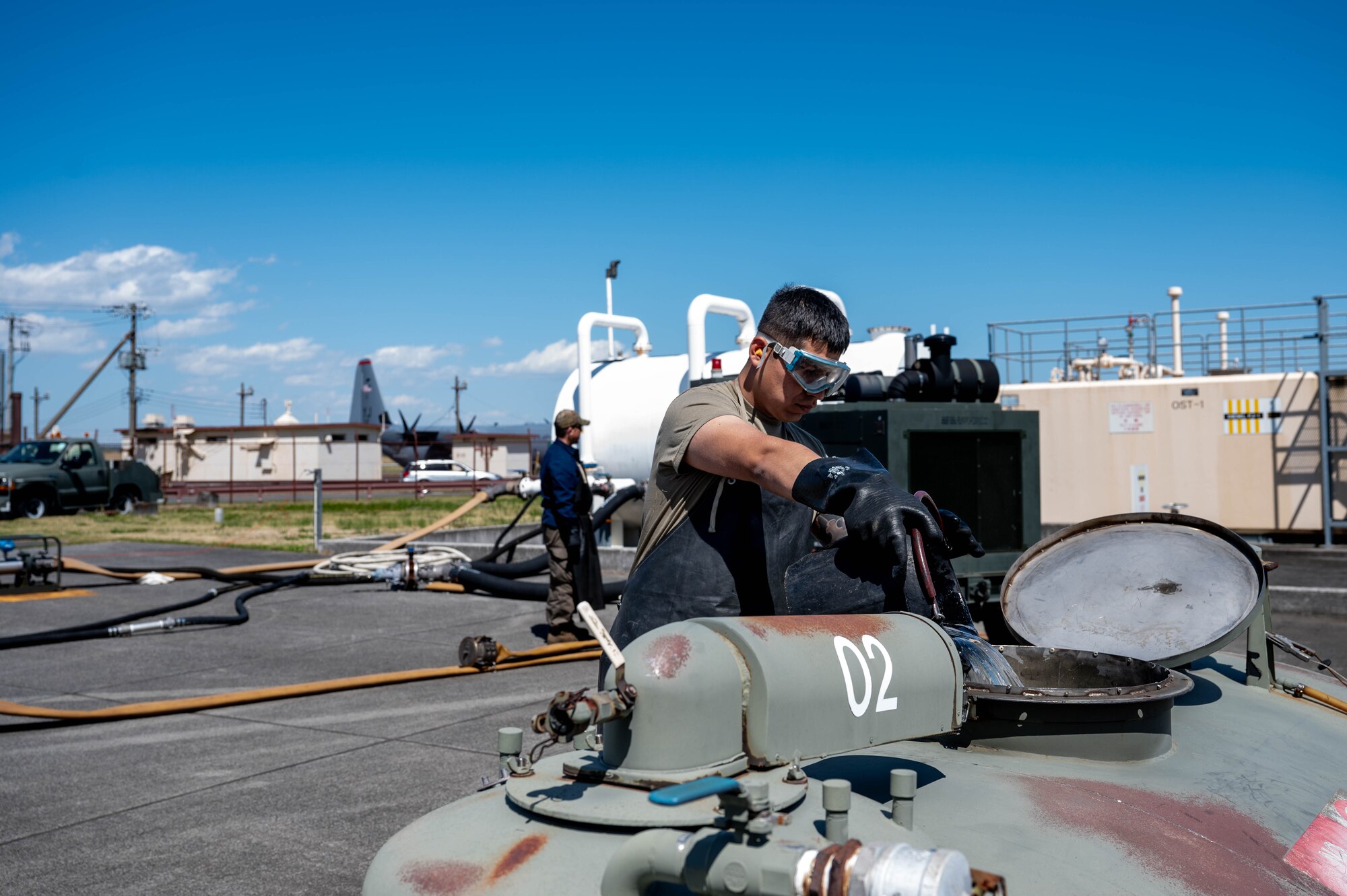 U.S. Air Force Airman 1st Class Juan Aparicio, 374th Logistics Readiness Squadron war reserve technician, returns fuel to a fuel bowser.