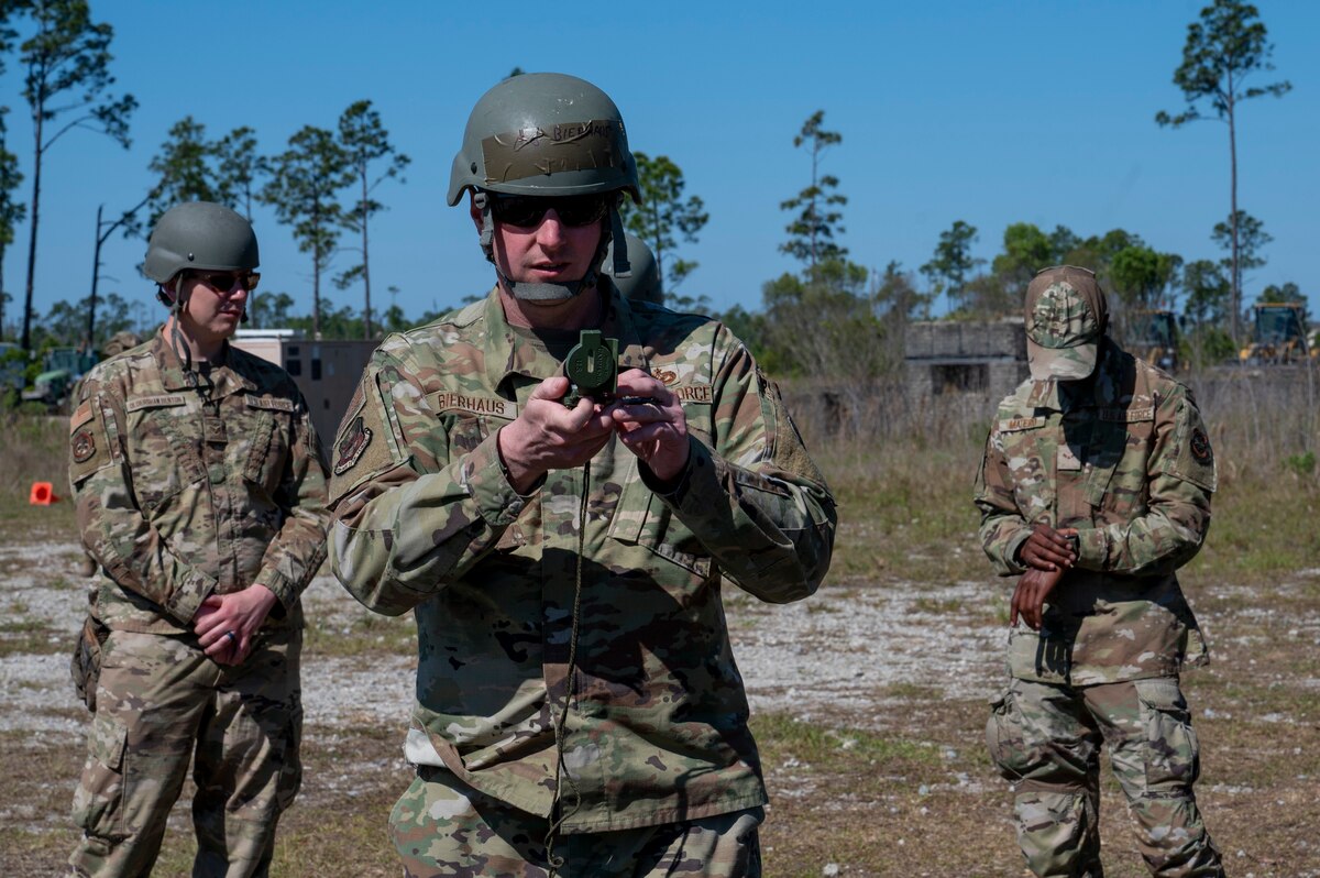 U.S. Air Force Maj. Zachary Bierhaus, the 22nd Air Task Force deputy chief of staff, utilizes a compass during exercise MAGPIE at Tyndall Air Force Base, Florida, April 13, 2025. Exercises like MAGPIE will continue to propel the 22nd ATF to operate effectively under stressful conditions in contested environments, resulting in a diverse force of Airmen prepared to undertake mission requirements. (U.S. photo by Airman 1st Class Samantha Thorn)