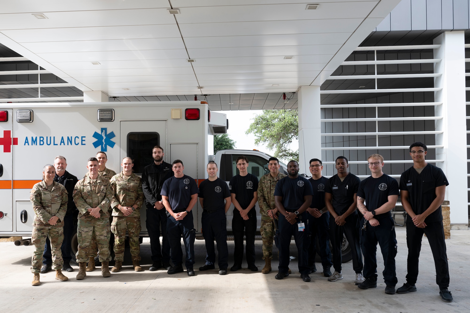 Fifteen staff members from the U.S. Air Force's Wilford Hall Emergency Department team pose in front of an ambulance