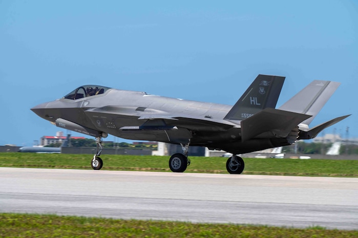 An aircraft lands on the flight line.