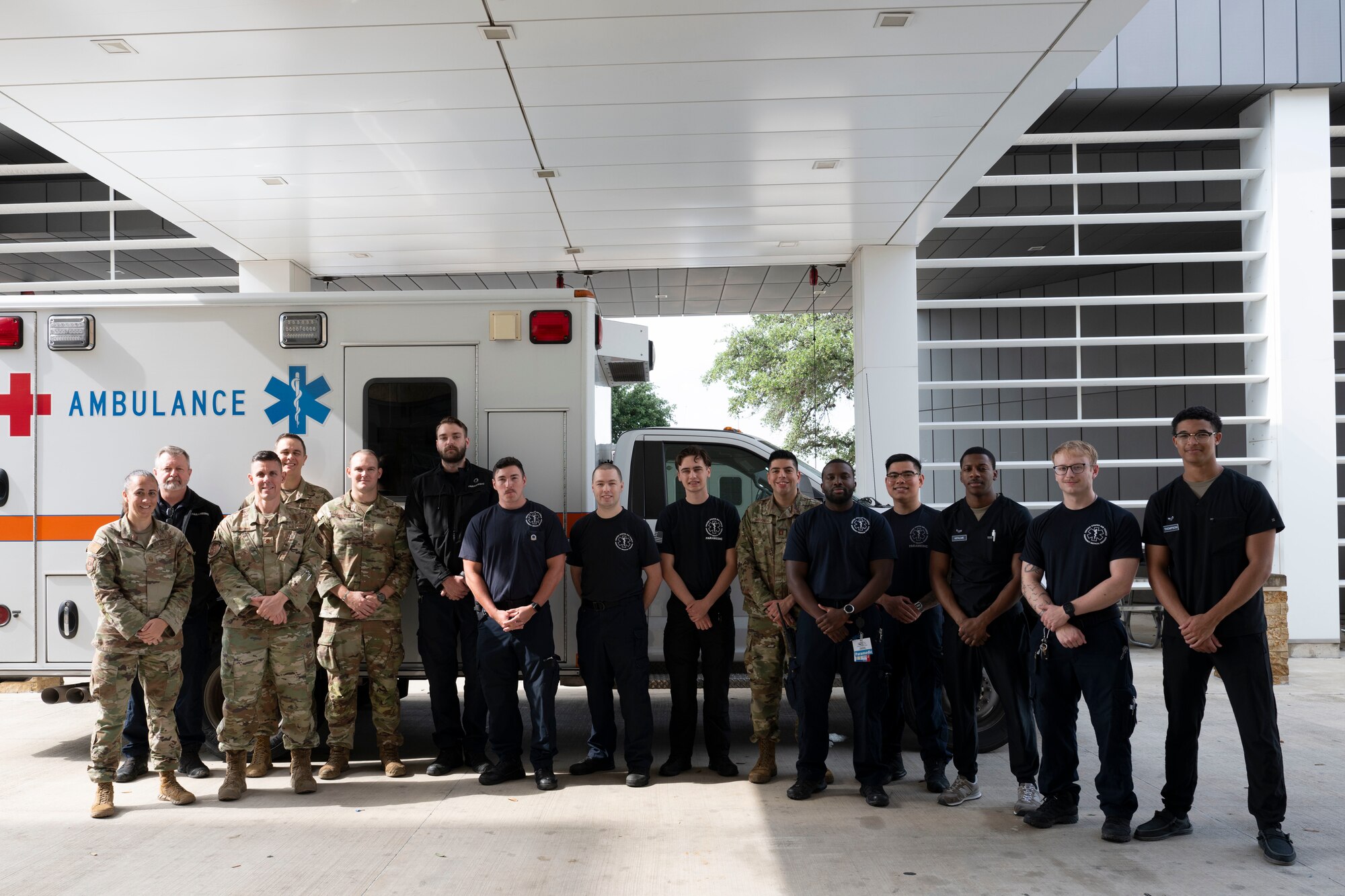 Fifteen staff members from the U.S. Air Force's Wilford Hall Emergency Department team pose in front of an ambulance
