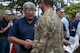 A U.S. Air Commando greets an Eagle Claw veteran the 45th anniversary ceremony of Operation Eagle Claw at Hurlburt Field, Florida., April 24, 2025.