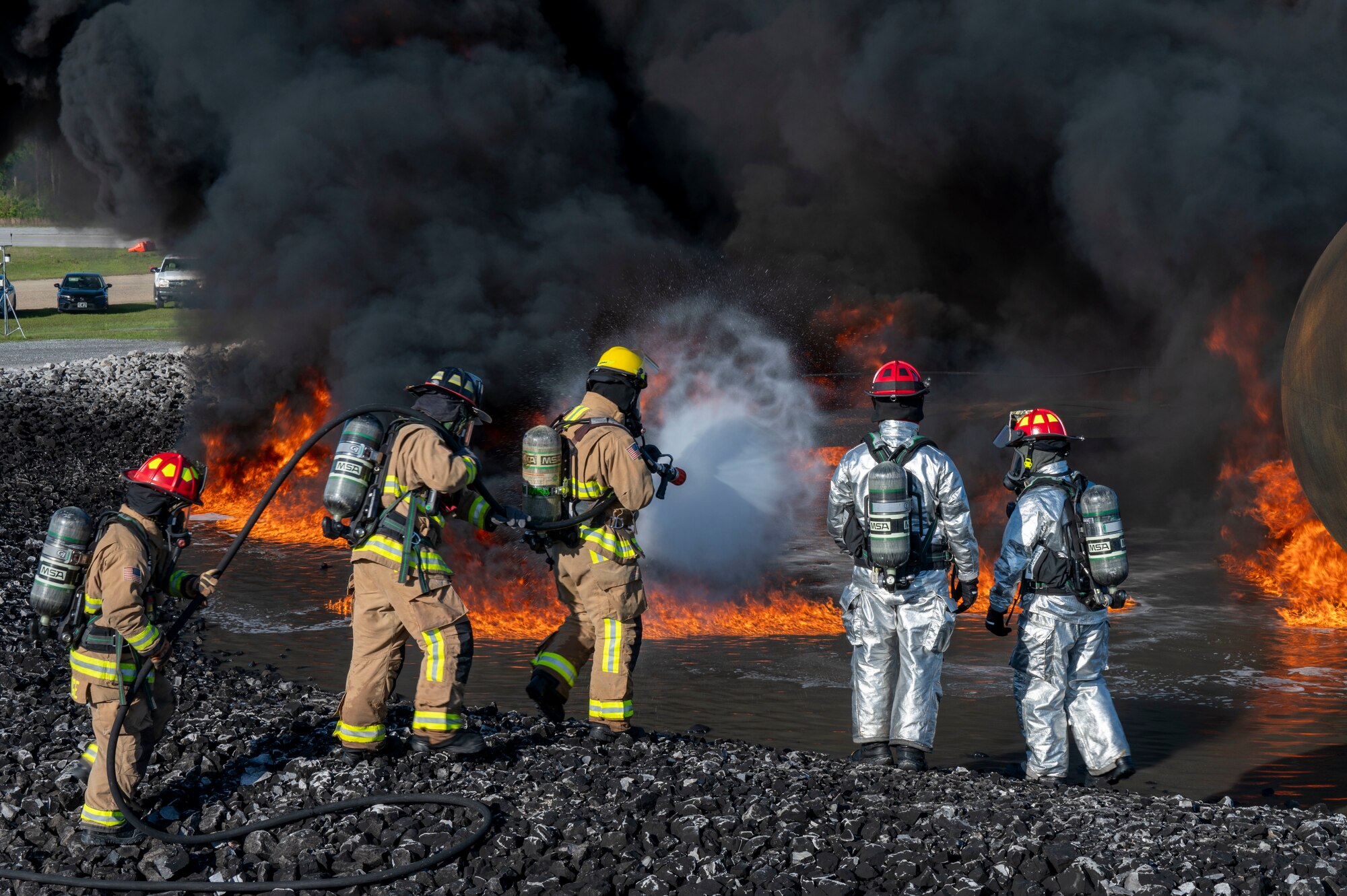 U.S. Air Force fire protection specialists, assigned to the 22nd Air Task Force, practice putting out a jet fuel related fire during a Silver Flag exercise at Tyndall Air Force Base, Florida, April 9, 2025. Aircraft Rescue and Firefighting Training is a biannual certification training that equips firefighters with the knowledge and skills to respond to aircraft emergencies. ATFs will allow the Air Force to provide a definable unit of action that has worked and trained together throughout the AFFORGEN cycle. (U.S. photo by Airman 1st Class Samantha Thorn)