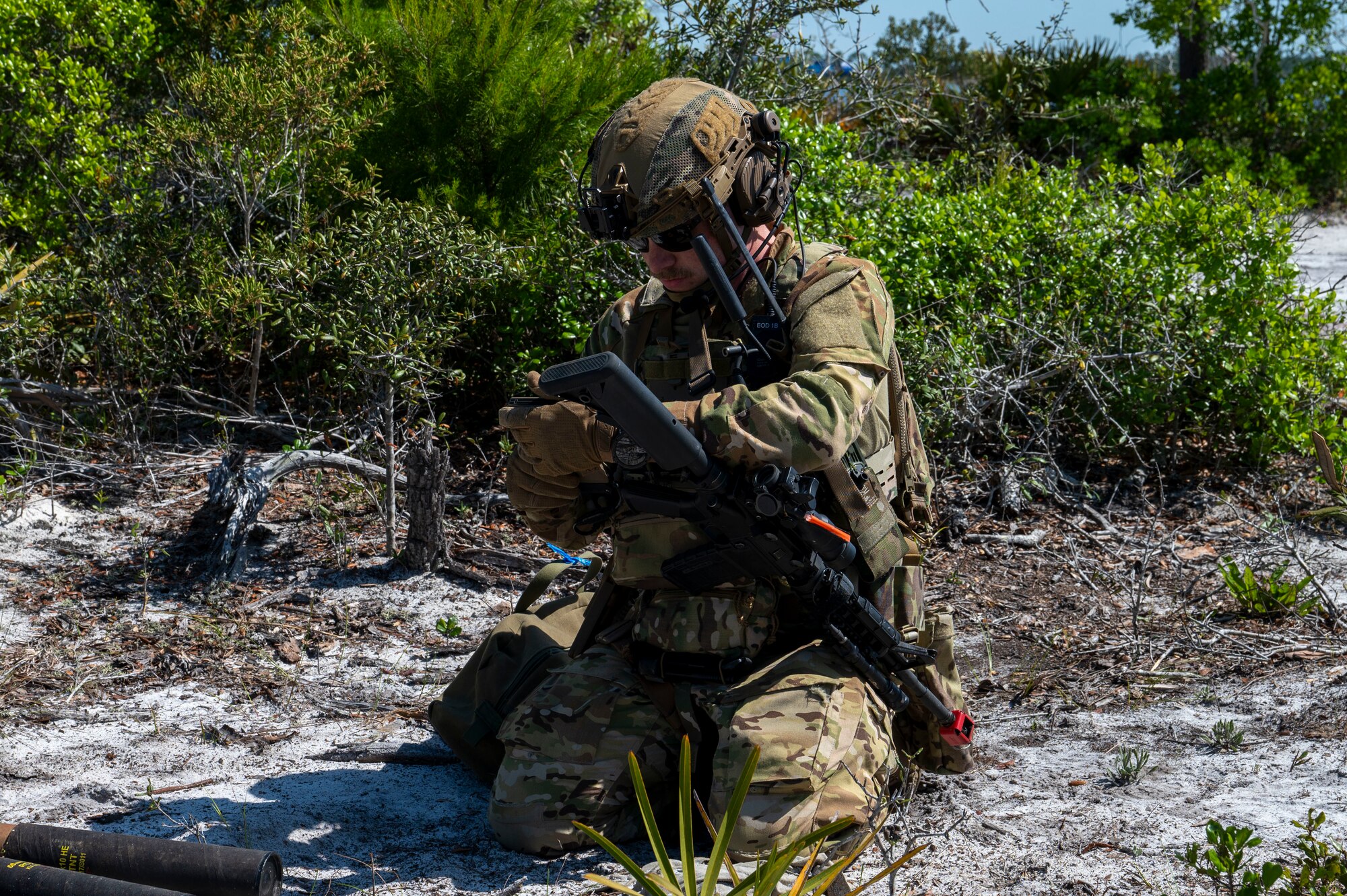 U.S. Air Force Senior Airman Seth Pare, Explosive Ordnance Disposal team leader assigned to the 22nd Air Task Force, identifies an improvised explosive device during a Silver Flag exercise at Tyndall Air Force Base, Florida, April 9, 2025. EOD specialists are responsible for the safe handling and disposal of hazardous explosive materials. Exercises like this will continue to propel the 22nd ATF to operate effectively under stressful conditions in contested environments, resulting in a diverse force of Airmen prepared to undertake mission requirements. (U.S. photo by Airman 1st Class Samantha Thorn)