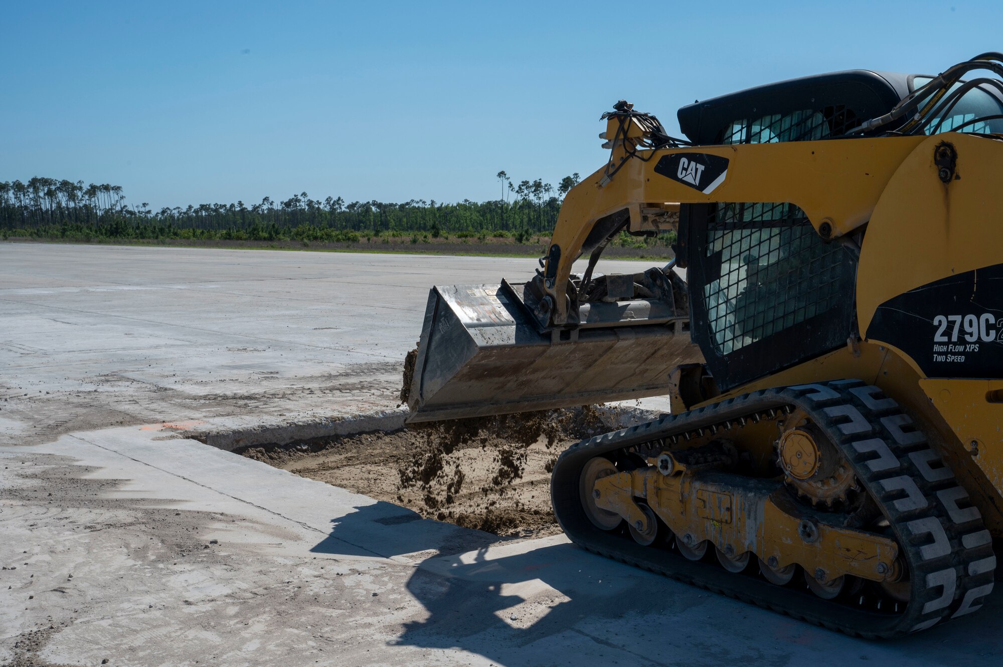 A U.S. Air Force Airmen assigned to the 22nd Air Task Force, operates a shovel excavator to perform airfield recovery on small craters during a Silver Flag exercise at Tyndall Air Force Base, Florida, April 8, 2025. Airfield recovery involves debris removal, crater repair, and infrastructure restoration to rapidly repair damage and restore airfield functionality, ensuring aircraft can continue operations efficiently. The 22nd ATF participated in rigorous exercises and diverse training programs to ensure that ATFs are fully prepared to execute assigned missions. (U.S. photo by Airman 1st Class Samantha Thorn)