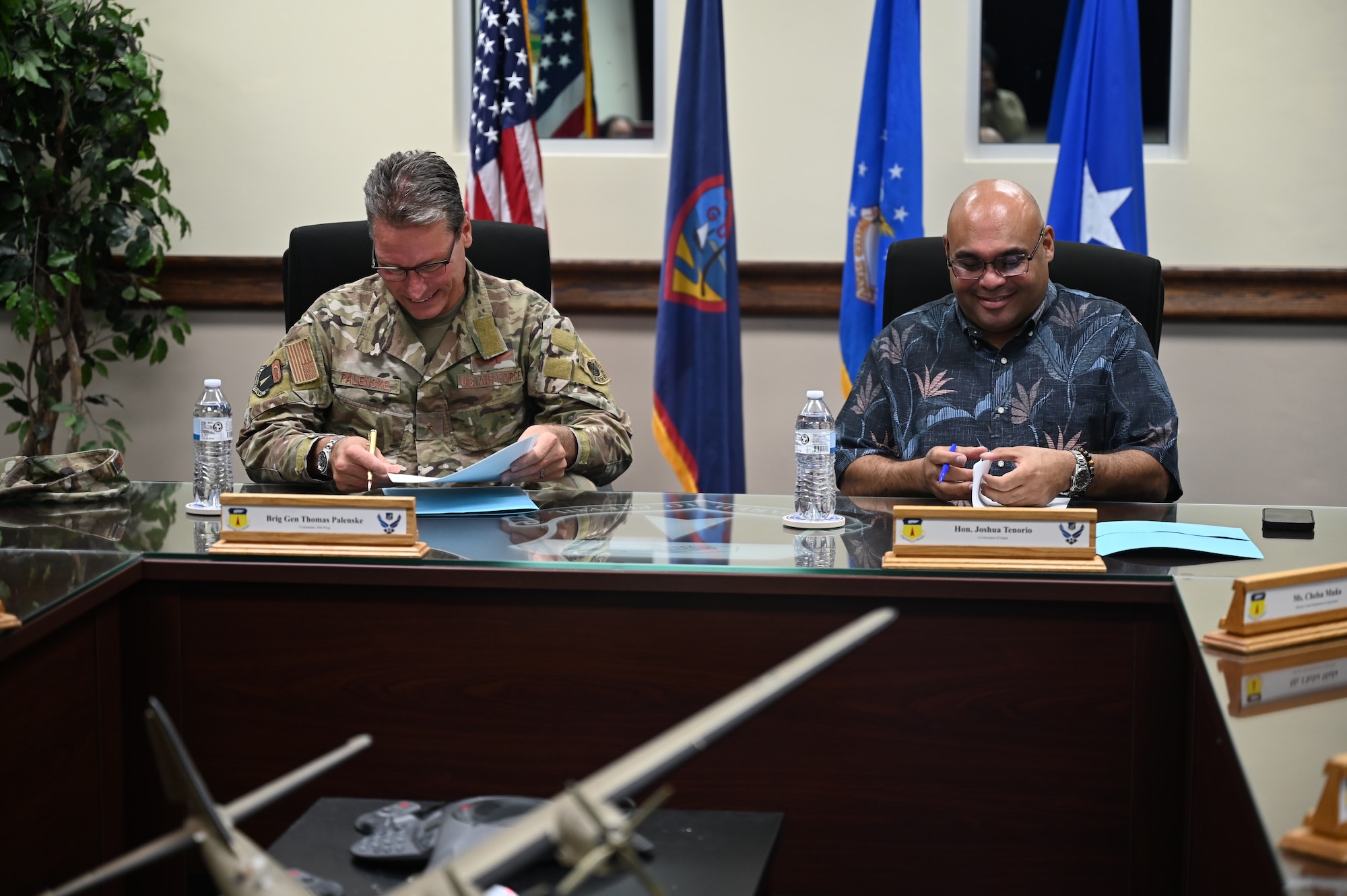 U.S. Air Force Brig. Gen. Thomas Palenske and Lt. Gov. Josh Tenorio sign agreement documents during the Boonie Dog support agreement signing at Andersen Air Force Base, Guam, April 24, 2025. Andersen AFB will provide support to the Government of Guam’s Stray Dog Task Force that will help lessen the number of stray dogs on the island. (U.S. Air Force photo by Airman 1st Class Adasha Williams)