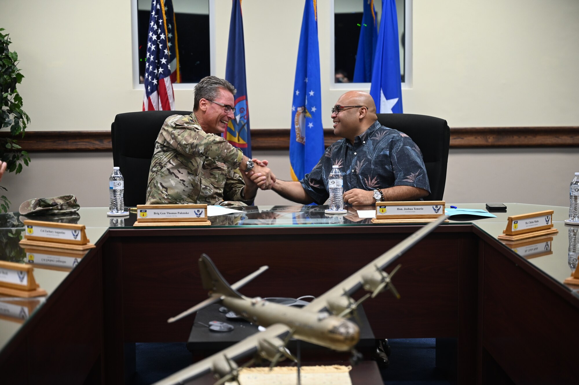 U.S. Air Force Brig. Gen. Thomas Palenske and Lt. Gov. Josh Tenorio shake hands after signing the Boonie Dog support agreement signing at Andersen Air Force Base, Guam, April 24, 2025. This ceremony was the first Intergovernmental Support Agreement (IGSA) with Andersen AFB and the Guam Department of Agriculture. (U.S. Air Force photo by Airman 1st Class Adasha Williams)