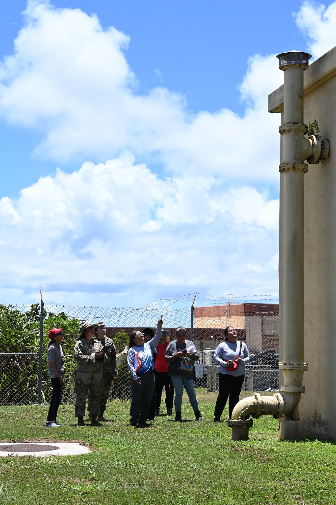 U.S. Air Force Bioenvironmental Engineering, 36th Medical Group, and 36th Civil Environmental Squadron, inspects a storage tank exterior with Guam Environmental Protection Agency (EPA), Water and Fuels Systems Maintenance and Infrastructure, during a sanitation survey inspection at Northwest Field, Andersen Air Force Base, Guam, April 23, 2025. A sanitary survey reviews eight areas including, the source, treatment, distribution system, finished water storage, pumps, monitoring/reporting, management/operations, and operator compliance. (U.S. Air Force photo by Airman 1st Class Adasha Williams)