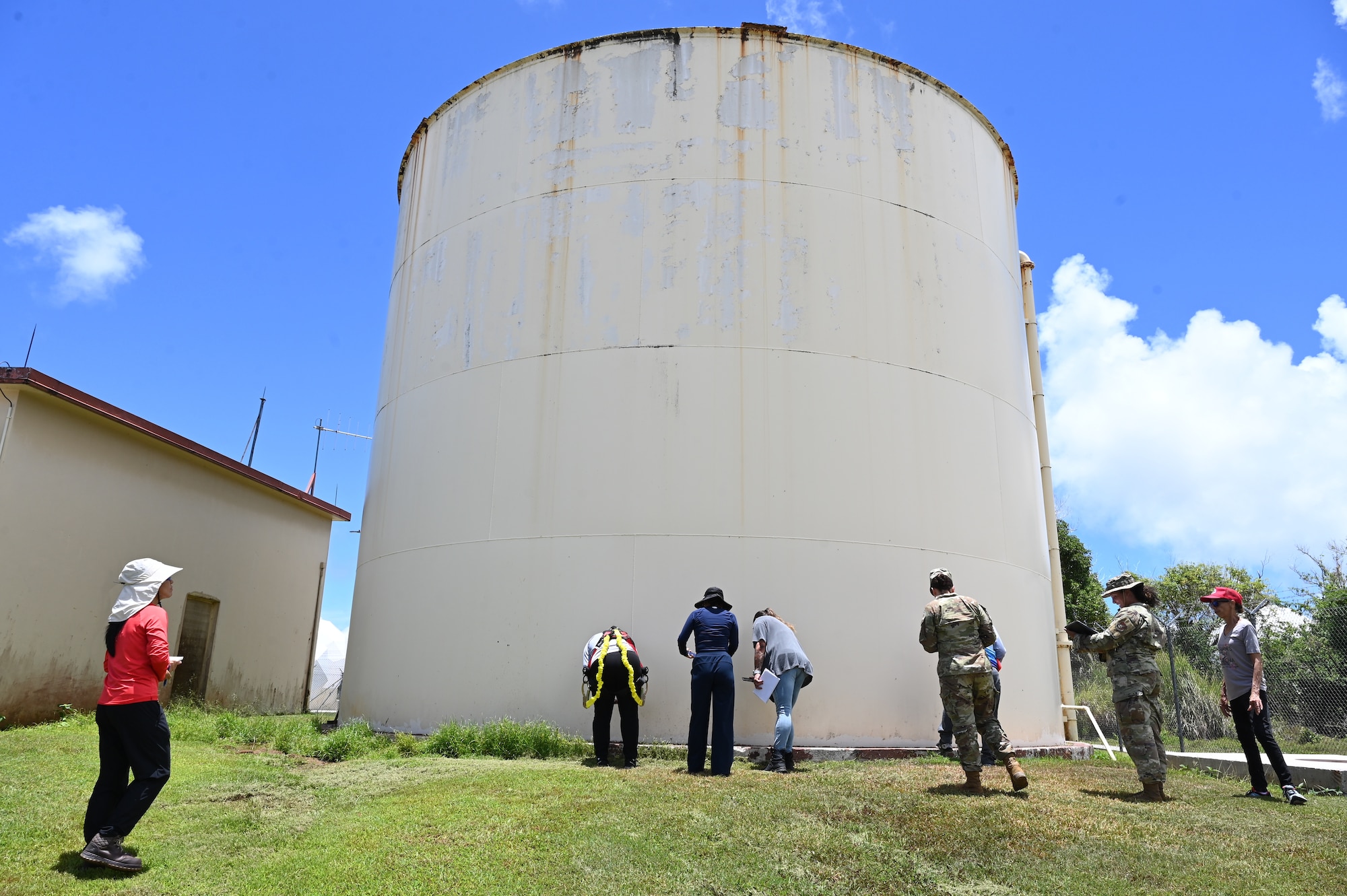 U.S. Air Force Bioenvironmental Engineering, 36th Medical Group, and 36th Civil Environmental Squadron, examines a water storage tank with Guam Environmental Protection Agency (EPA), Water and Fuels Systems Maintenance and Infrastructure, and other contractors during a sanitation survey inspection at Northwest Field, Andersen Air Force Base, Guam, April 23, 2025. EPA is a nation-wide program for environmental protection of land, water, and air against pollutants. (U.S. Air Force photo by Airman 1st Class Adasha Williams)