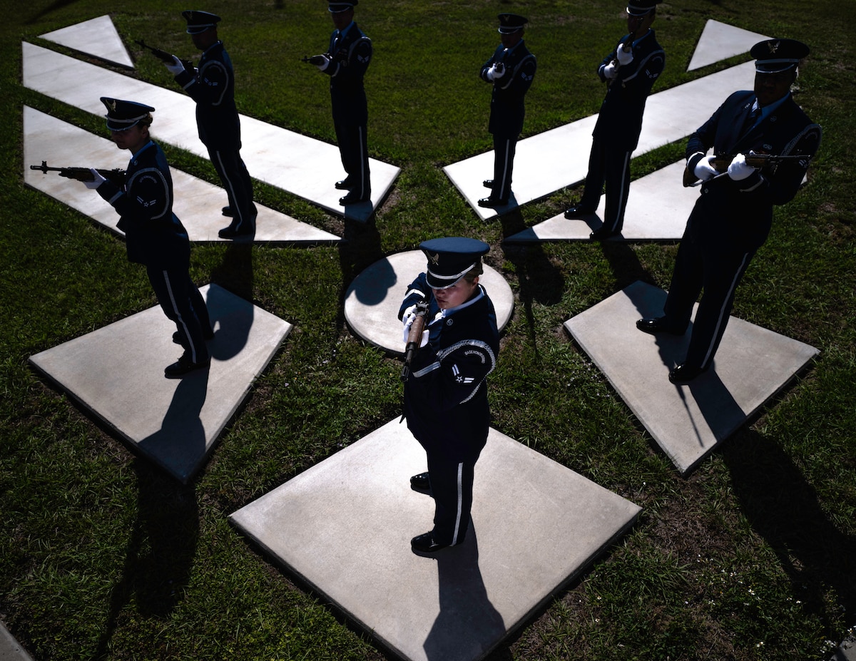 Airmen standing on the Air Force symbol