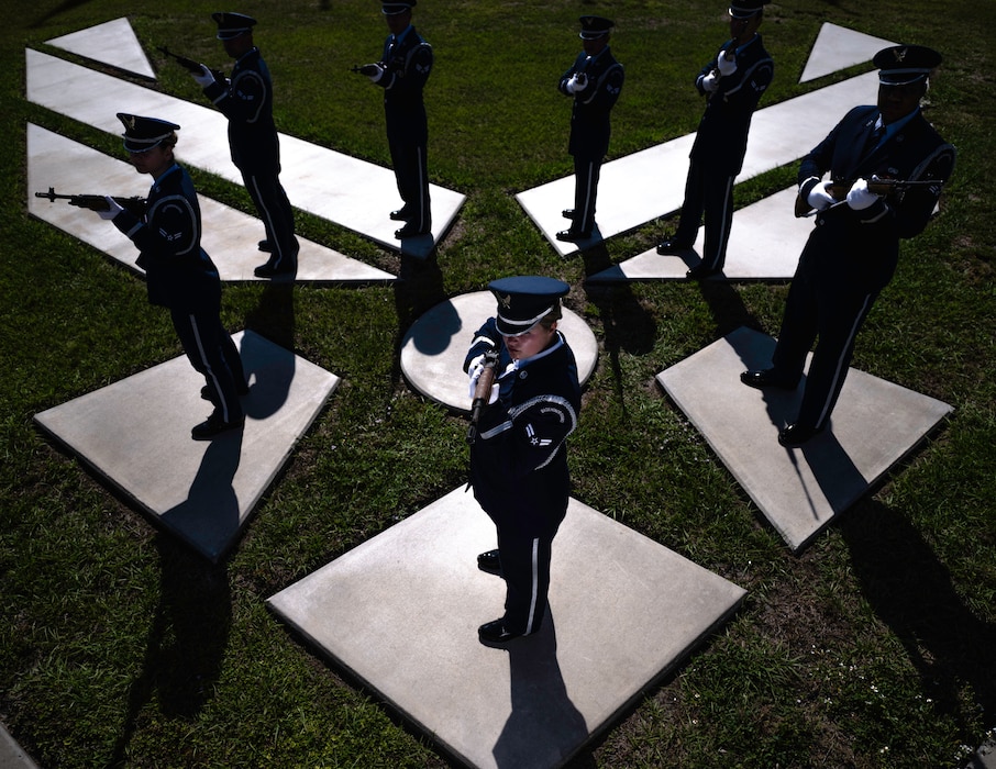 Airmen standing on the Air Force symbol