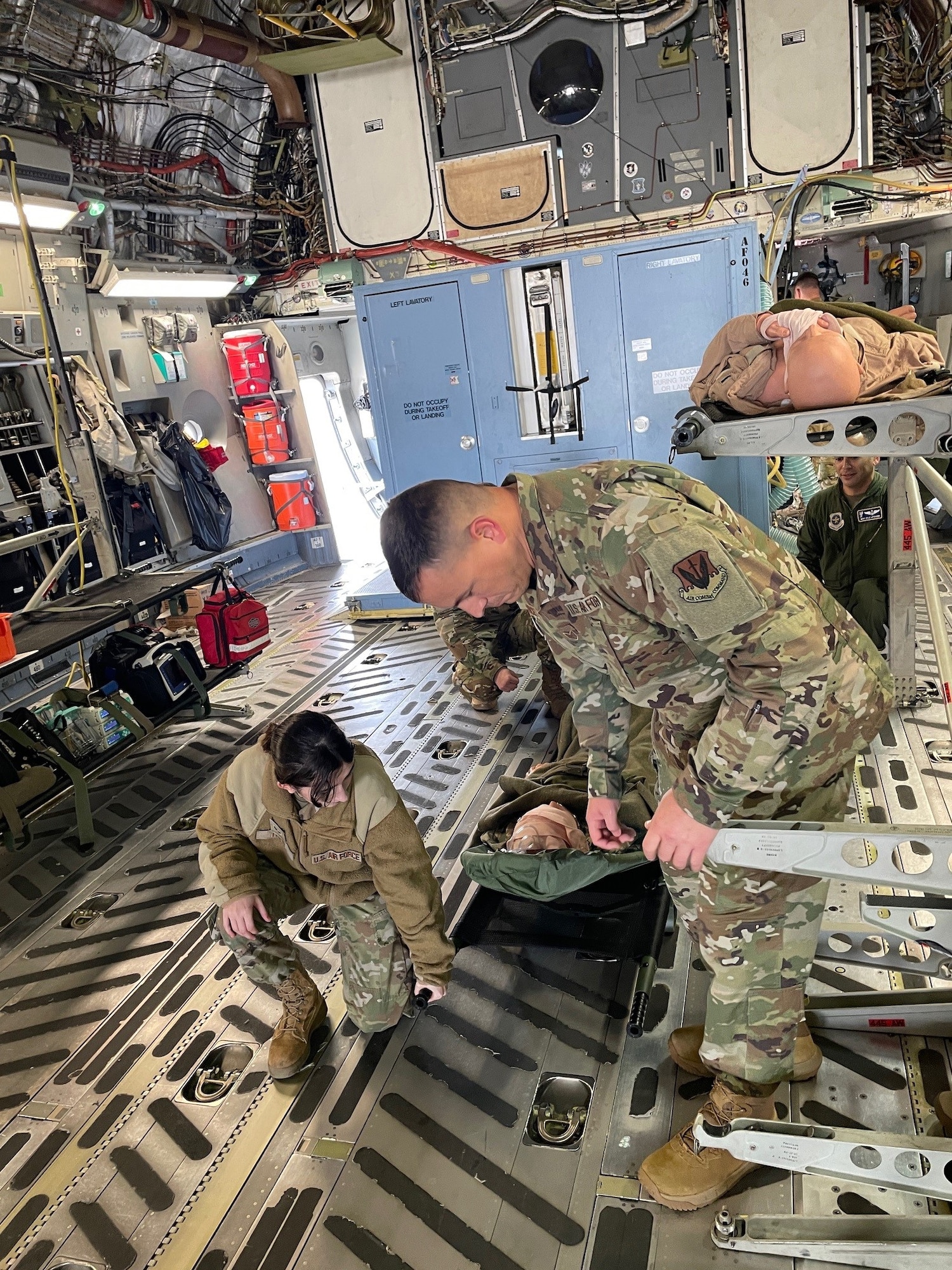 U.S. Air Force Senior Airman Hannah Trent, 20th Operational Medical Readiness Squadron Flight Medicine medical technician, left, and Staff Sgt. Ryan Eustace, 20th Medical Group health services administrator, work together to litter-carry patients off a C-17 Globemaster III at Shaw Air Force Base, S.C., March 13, 2025. The 20th MDG Airmen received comprehensive briefings from 375th Aeromedical Evacuation Training Squadron crew members, stationed at Wright Patterson AFB, Ohio, ranging from the initial call for AE capabilities and the paperwork involved, to the baggage requirements for patients and actual on-board care. (U.S. Air Force courtesy photo)