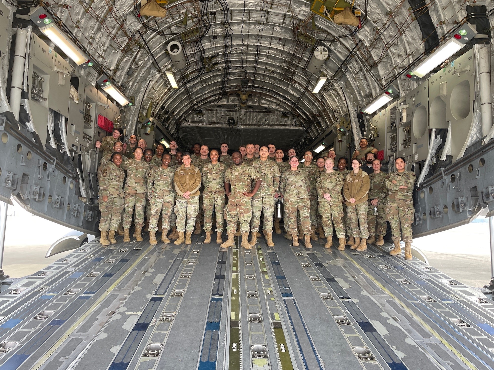 U.S. Air Force 375th Aeromedical Evacuation Training Squadron instructors, stationed at Wright Patterson Air Force Base, Ohio, and 20th Medical Group Airmen gather for a group photo inside a C-17 Globemaster III at Shaw AFB, S.C., March 13, 2025. The 20th MDG Airmen received comprehensive briefings from the 375th AETS crew members, ranging from the initial call for AE capabilities and the paperwork involved, to the baggage requirements for patients and actual on-board care. (U.S. Air Force courtesy photo)