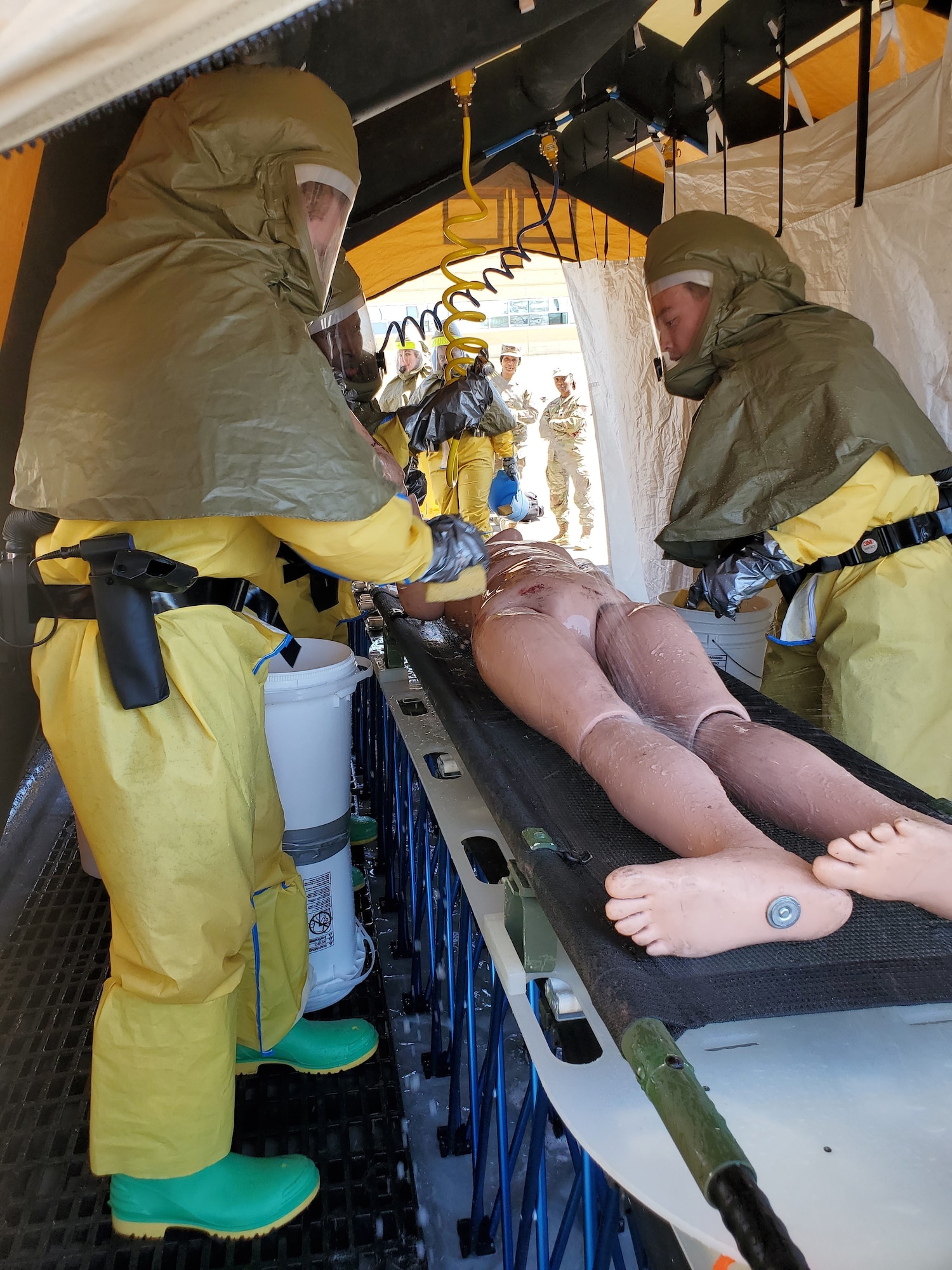 U.S. Air Force 20th Medical Group Airmen conduct decontamination training on a training mannequin at Shaw Air Force Base, S.C., March 27, 2025. Wearing full personal protective equipment, team members practiced crucial procedures to prevent contamination spread. (U.S. Air Force courtesy photo)