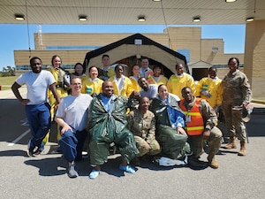 U.S. Air Force 20th Medical Group Airmen pose for a photo after conducting decontamination training at Shaw Air Force Base, S.C., March 27, 2025. After completing the training, the students were certified in Hazardous Waste Operations and Emergency Response to the operational level. (U.S. Air Force courtesy photo illustration) (This photo was edited to blur badge information)