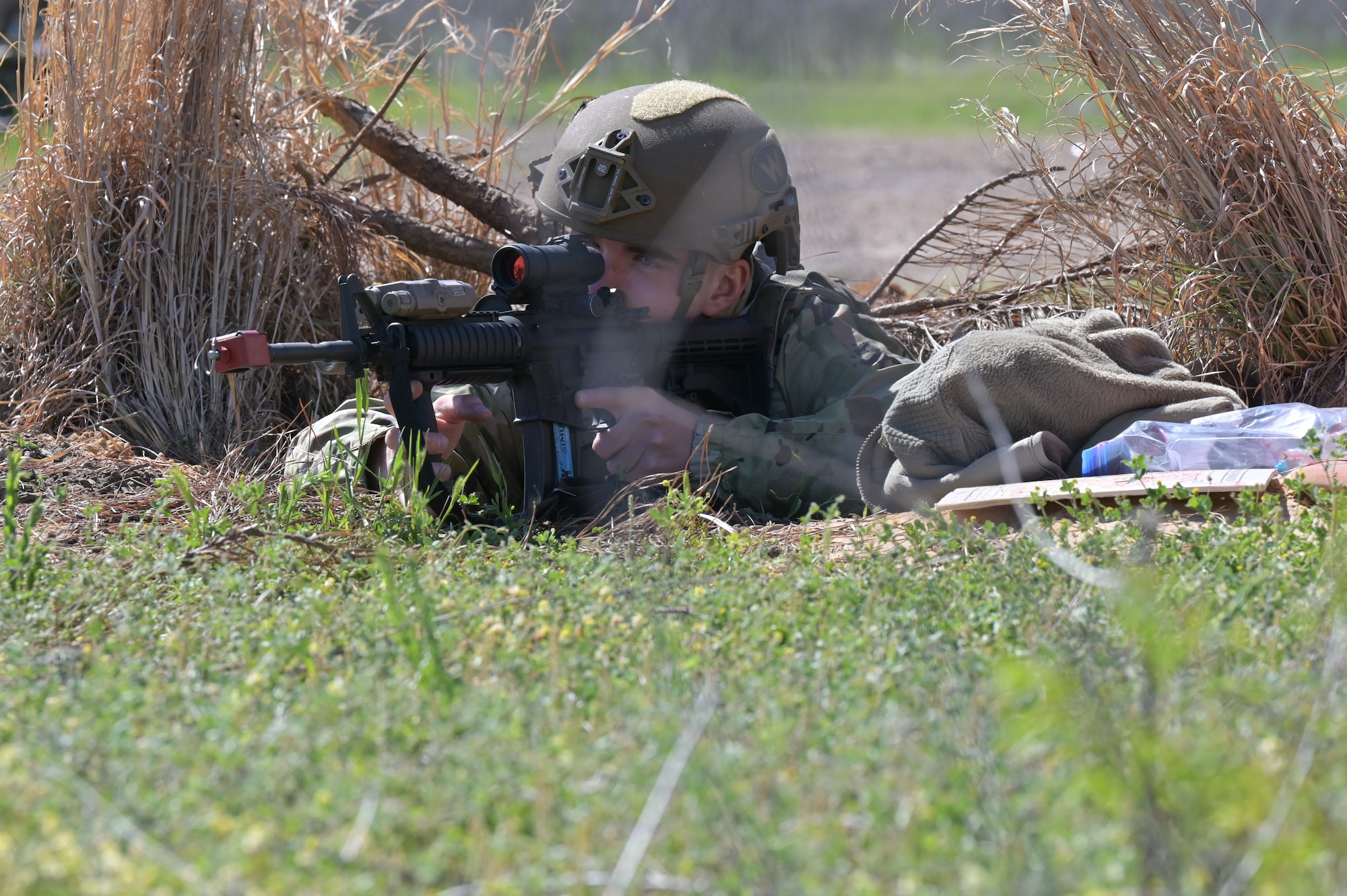 Airman Michael Connolly, 14th Security Forces Squadron Airmen, sights in on a target during a field training exercise at Columbus Air Force Base, Mississippi, April 16, 2025. The 72-hour Agile Combat Employment exercise emphasized mobility, communications and reconnaissance. (U.S. Air Force photo by Airman 1st Class Joseph Curzi)