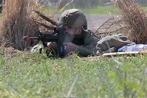 Airman Michael Connolly, 14th Security Forces Squadron Airmen, sights in on a target during a field training exercise at Columbus Air Force Base, Mississippi, April 16, 2025. The 72-hour Agile Combat Employment exercise emphasized mobility, communications and reconnaissance. (U.S. Air Force photo by Airman 1st Class Joseph Curzi)