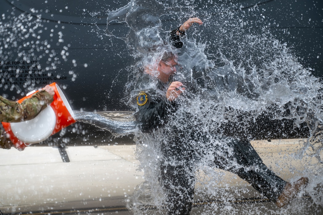 Airman being splashed with water
