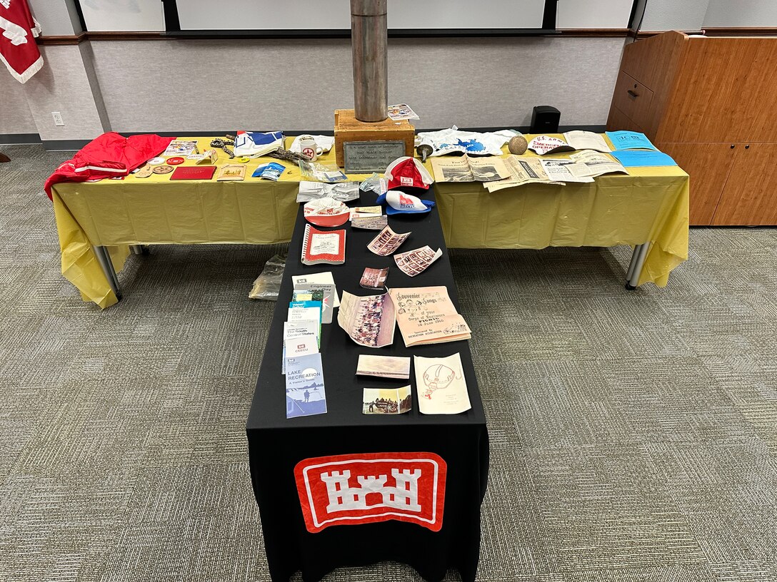 Buried in April 1990, the district's time capsule was opened as part of the 75th anniversary festivities. Some of the items within the capsule were various brochures, patches, buttons, and emergency operations materials.  There were also photographs of the office of counsel, the Lavon Lake staff, Lavon Lake flood gates, district engineers, the executive staff, and the engineering staff (Military Branch)