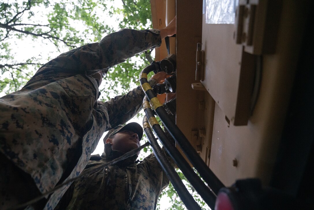 U.S. Marines with Marine Tactical Air Command Squadron (MTACS) 48, 4th Marine Aircraft Wing, maintain communication and network capabilties during Northern Lightning 23 at Volk Field Air National Guard Base, Wisconsin, Aug. 14, 2023. Northern Lightning is one of the seven Air National Guard joint accredited readiness exercises that increases military readiness by providing participating units a tactical, joint training environment to execute realistic combat training. (U.S. Marine Corps photo by Cpl. Ujian Gosun)