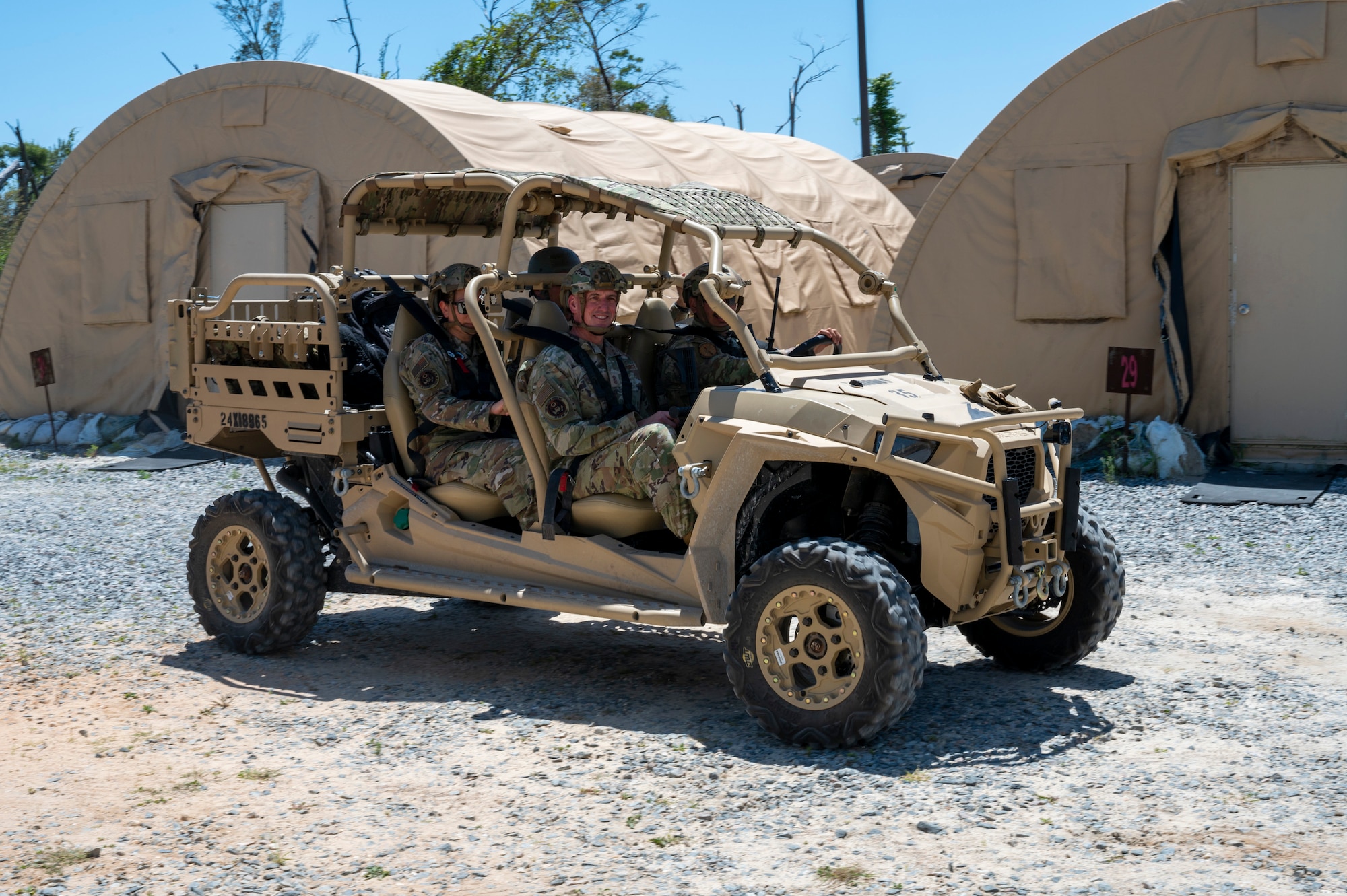 Chief Master Sgt. of the Air Force David Flosi rides in an MRZR during a tour at Tyndall Air Force Base, Florida, April 16, 2025. The 22nd Air Task Force is participating in rigorous exercises and diverse training programs to ensure Airmen are fully prepared to execute assigned missions. (U.S. Air Force photo by Airman 1st Class Samantha Thorn).
