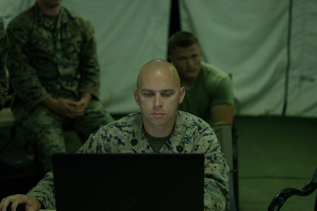 U.S. Marine Corps Gunnery Sgt. Ryan McClane, a native of Arizona and a radar technician with Marine Air Control Squadron (MACS) 24, Marine Air Control Group (MACG) 48, 4th Marine Aircraft Wing (MAW), monitors air space during a Base Defense Zone (BDZ) exercise at Marine Corps Auxiliary Landing Field Bogue, North Carolina, June 11, 2024. Marines from 2nd Low Altitude Air Defense (LAAD) Battalion, MACS-24 and Marine Wing Support Squadron (MWSS) 271 executed this exercise to enhance confidence and proficiency in BDZ operations. (U.S. Marine Corps photo by Lance Cpl. Bryan Giraldo)