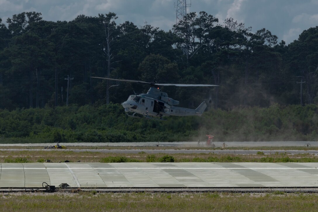 A U.S. Marine Corps UH-1Y Venom with Marine Light Attack Helicopter Squadron (HMLA) 167 lands at a landing field during a Base Defense Zone (BDZ) exercise at Marine Corps Auxiliary Landing Field Bogue, North Carolina, June 11, 2024. Marines from 2nd Low Altitude Air Defense (LAAD) Battalion, Marine Air control Squadron (MACS) 24 and Marine Wing Support Squadron (MWSS) 271 executed this exercise to enhance confidence and proficiency in BDZ operation (U.S. Marine Corps photo by Lance Cpl. Bryan Giraldo)